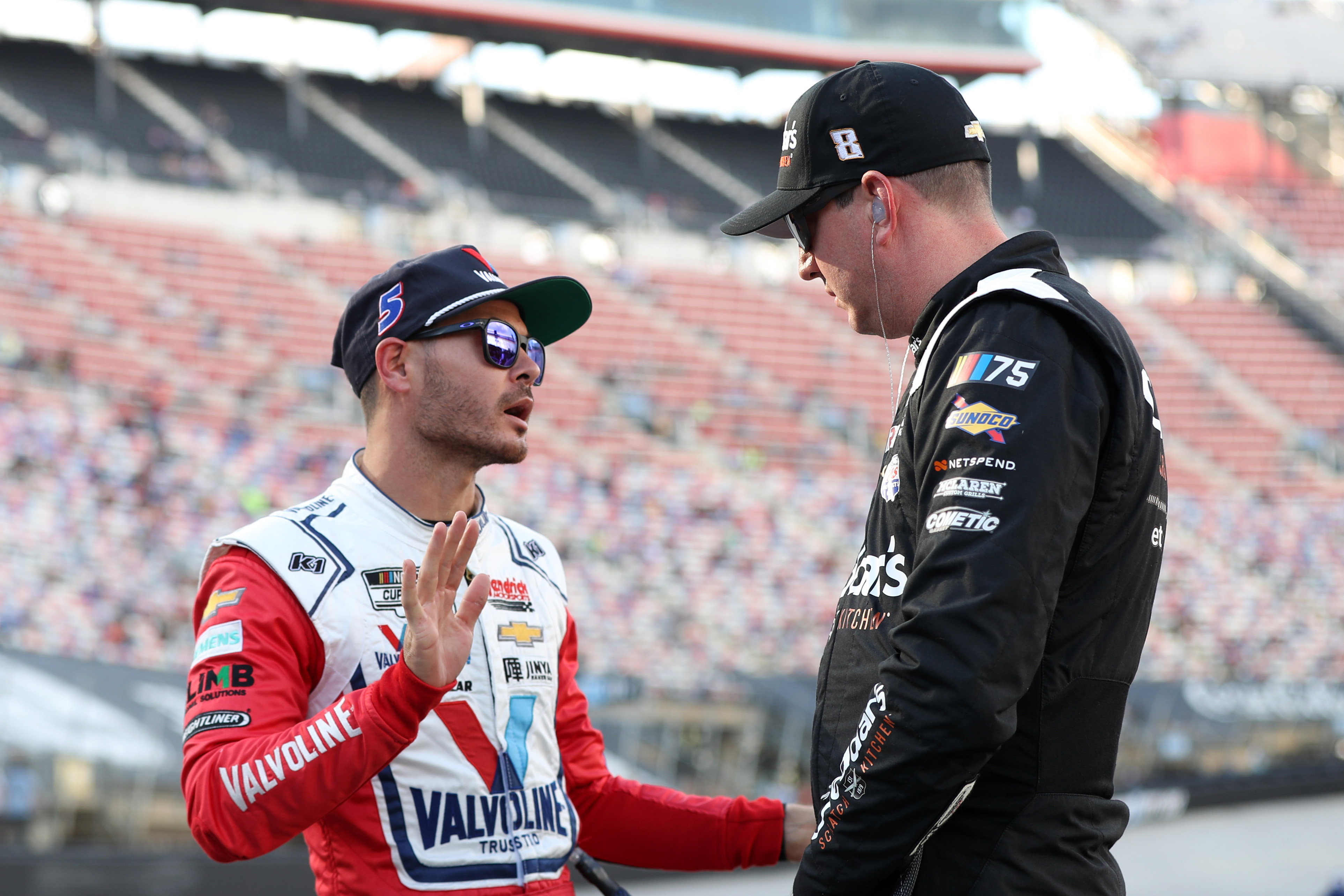 Kyle Larson and Kyle Busch talk on the grid during qualifying for the NASCAR Cup Series Bass Pro Shops Night Race at Bristol Motor Speedway on September 15, 2023 in Bristol, Tenness | Source: Getty Imagesee