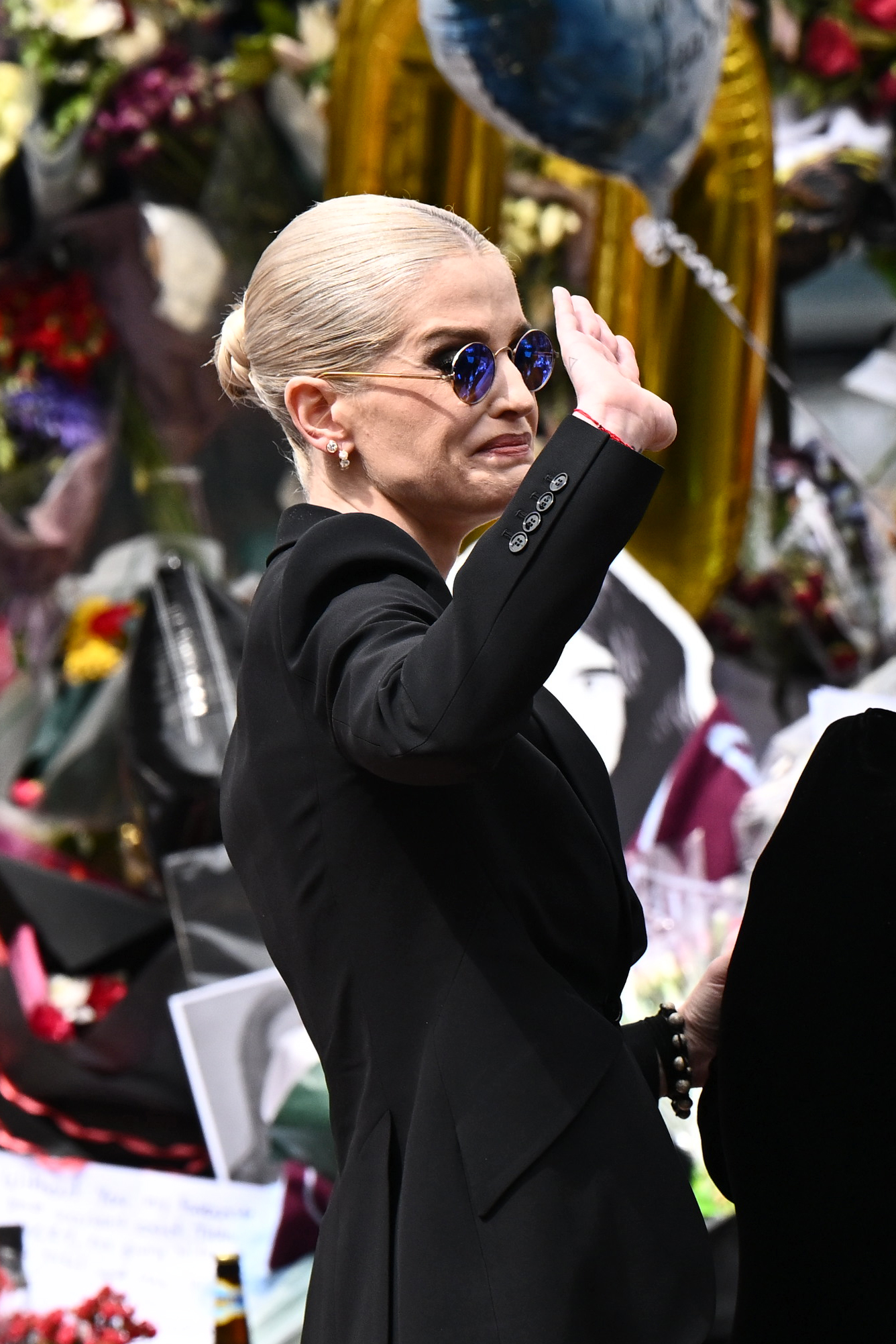 Kelly Osbourne greets fans as she arrives to view tributes to the late Ozzy Osbourne on July 30, 2025 in Birmingham, England. | Source: Getty Images