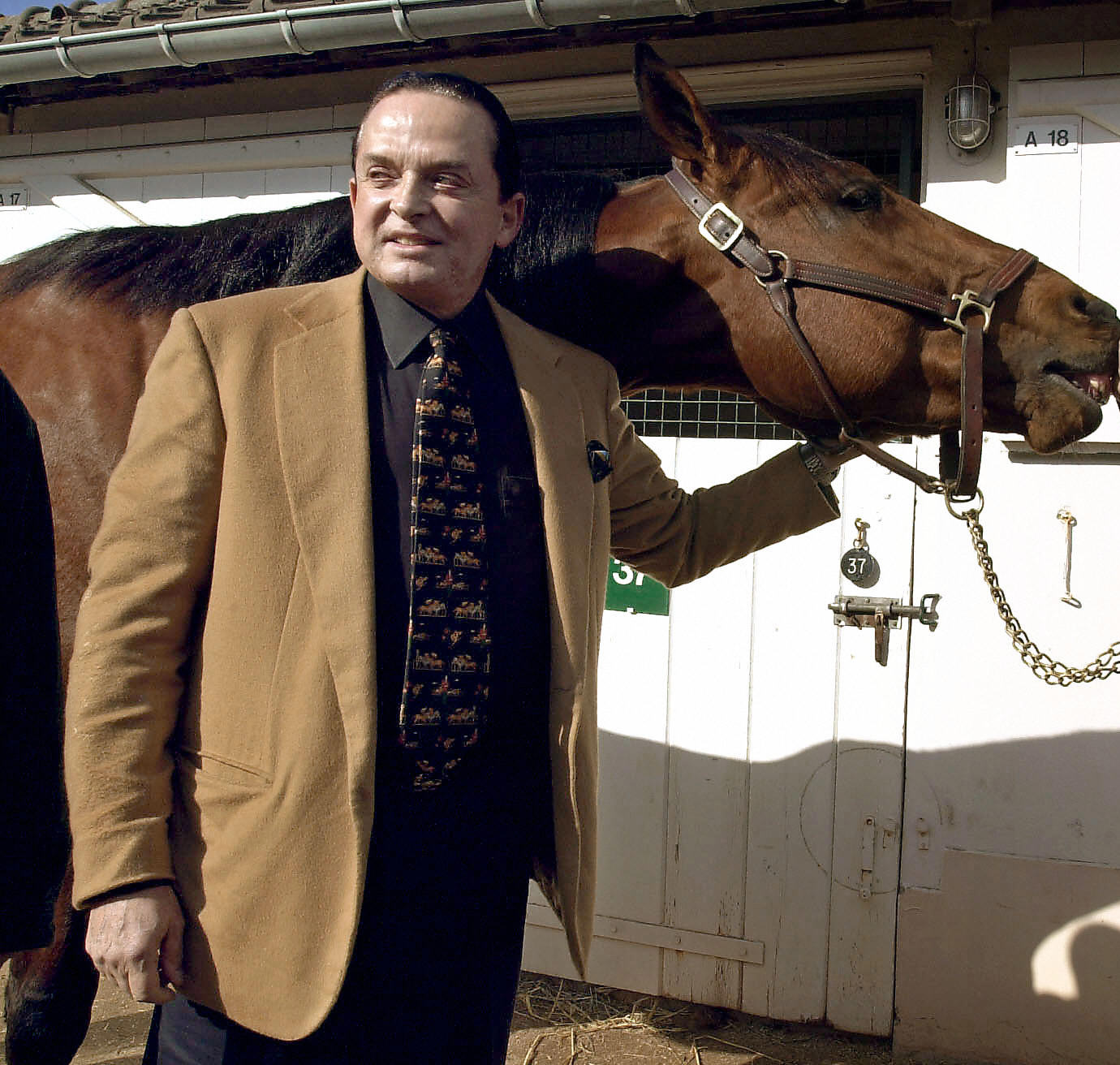 Alec Wildenstein posing with his horse Kesaco Phedo, winner of the three-year Criterium and of the Prix de Vincennes, on March 7, 2002. | Source: Getty Images
