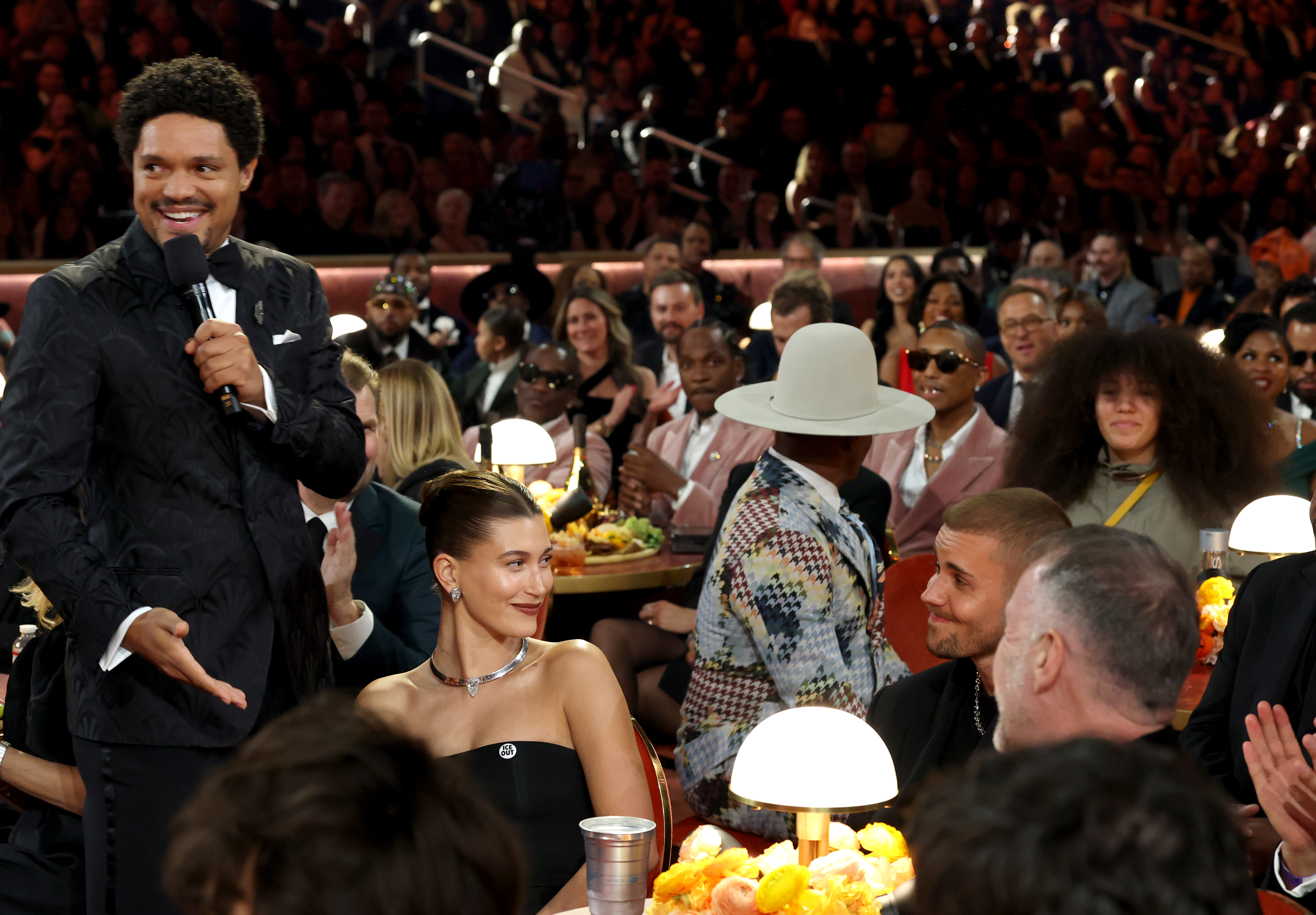 Trevor Noah talks to Justin and Hailey Bieber during the awards show.