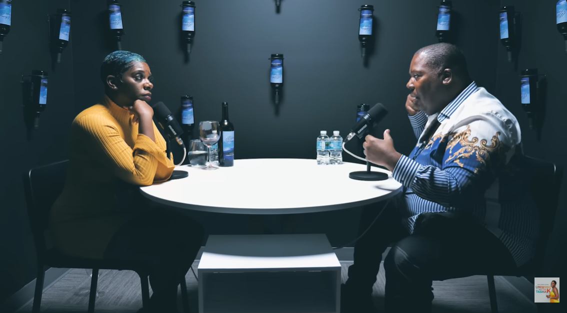 Filmed in a dark-toned studio, Salaam joins host Tasha K for a sit-down interview on "UNWINE WITH TASHA K" | Source: YouTube/unwinewithtashak