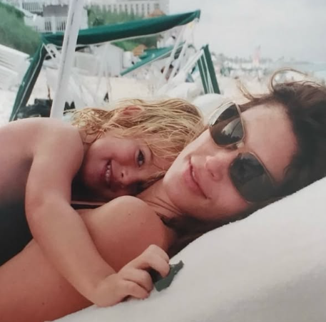 Cindy Crawford cuddles her young son Presley Gerber during a beach day, in a sweet throwback photo shared by the supermodel on Facebook. | Source: Facebook/Cindy Crawford