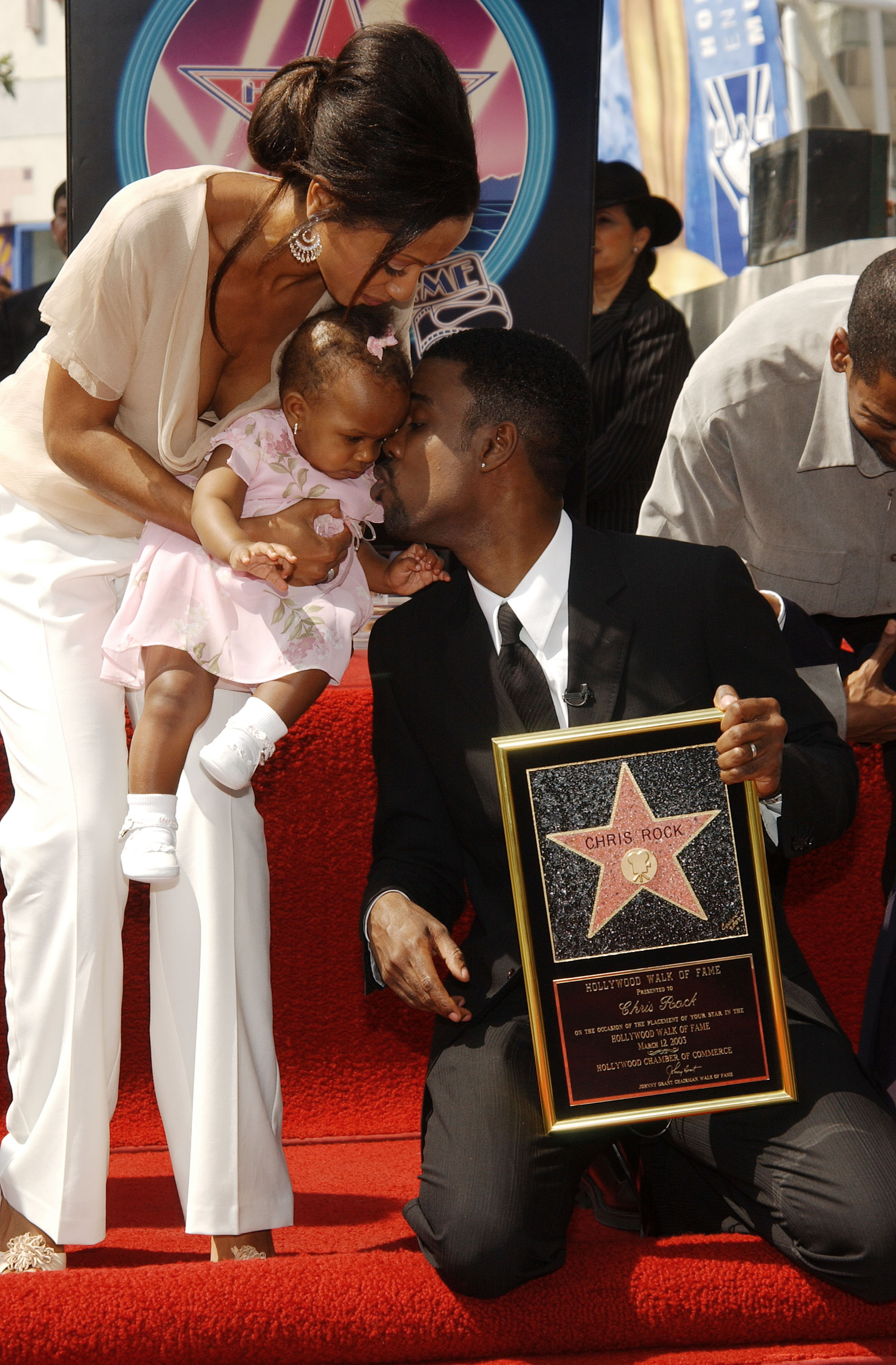The couple with their daughter attends the ceremony honoring the comedian and actor with a star on the Hollywood Walk of Fame on March 12, 2003  | Source: Getty Images