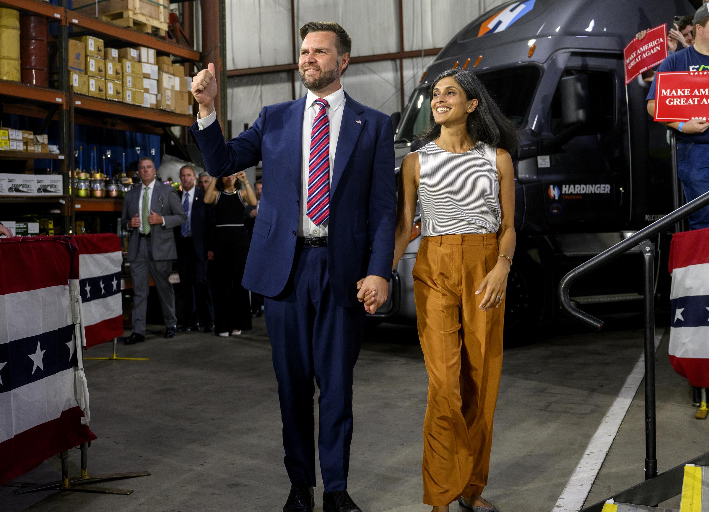 J.D. Vance walks on stage with his wife, Usha before speaking at a rally on August 28, 2024 | Source: Getty Images