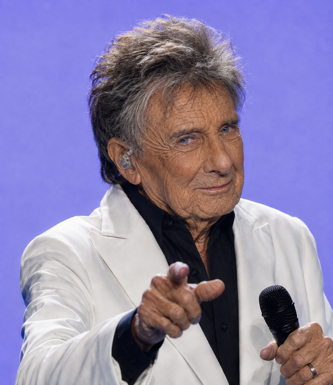This version feels more direct because Manilow appears to gesture toward the viewer. The familiar concert styling remains, but the more serious expression gives the image a different mood from the others. | Source: ChatGPT