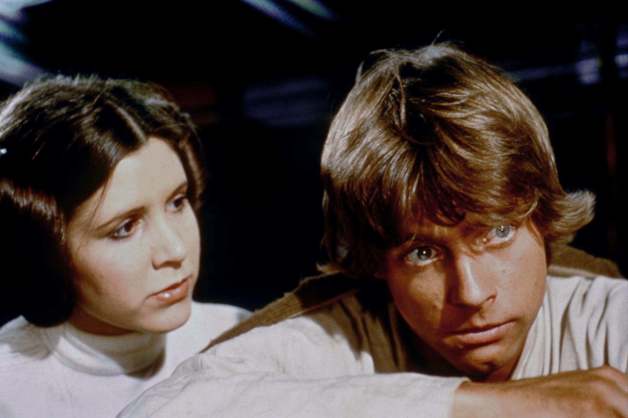 Carrie Fisher and Mark Hamill shared the frame as Princess Leia and Luke Skywalker during production of "Star Wars: A New Hope," with both actors wearing their characters' now-iconic costumes. The close-up captured Hamill during the film that would establish him as a major star once it reached theaters in 1977. His features here predated the car crash that fractured his nose and left cheekbone before the movie's release.