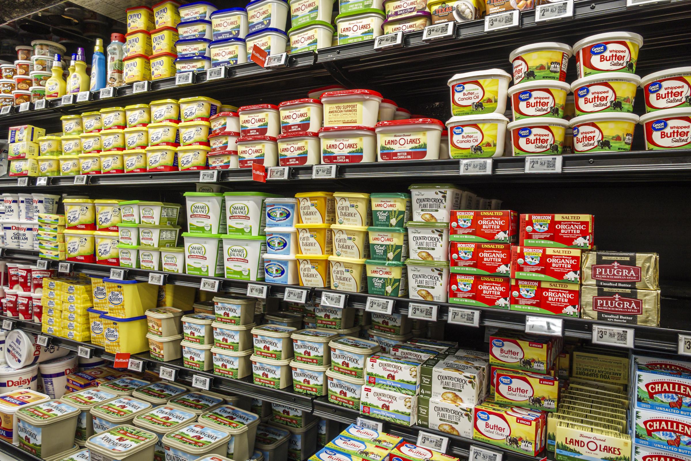 Butter products displayed in a refrigerated grocery section. | Source: Getty Images