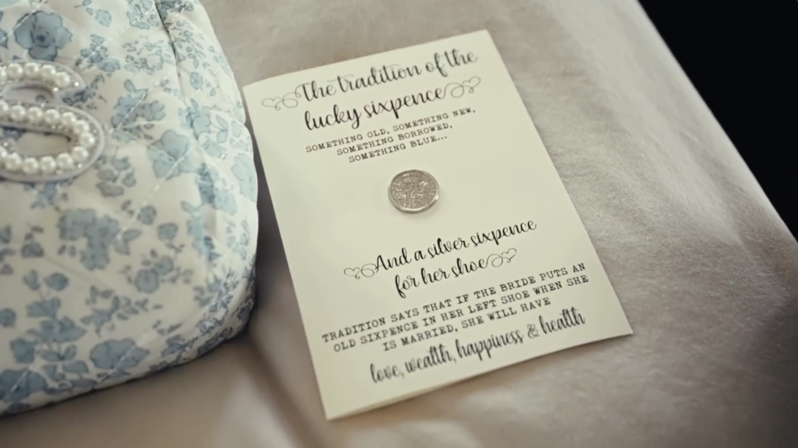 A silver sixpence card and floral-patterned accessory highlight a wedding tradition tied to good fortune for the bride. | Source: Instagram/donaldjtrumpjr