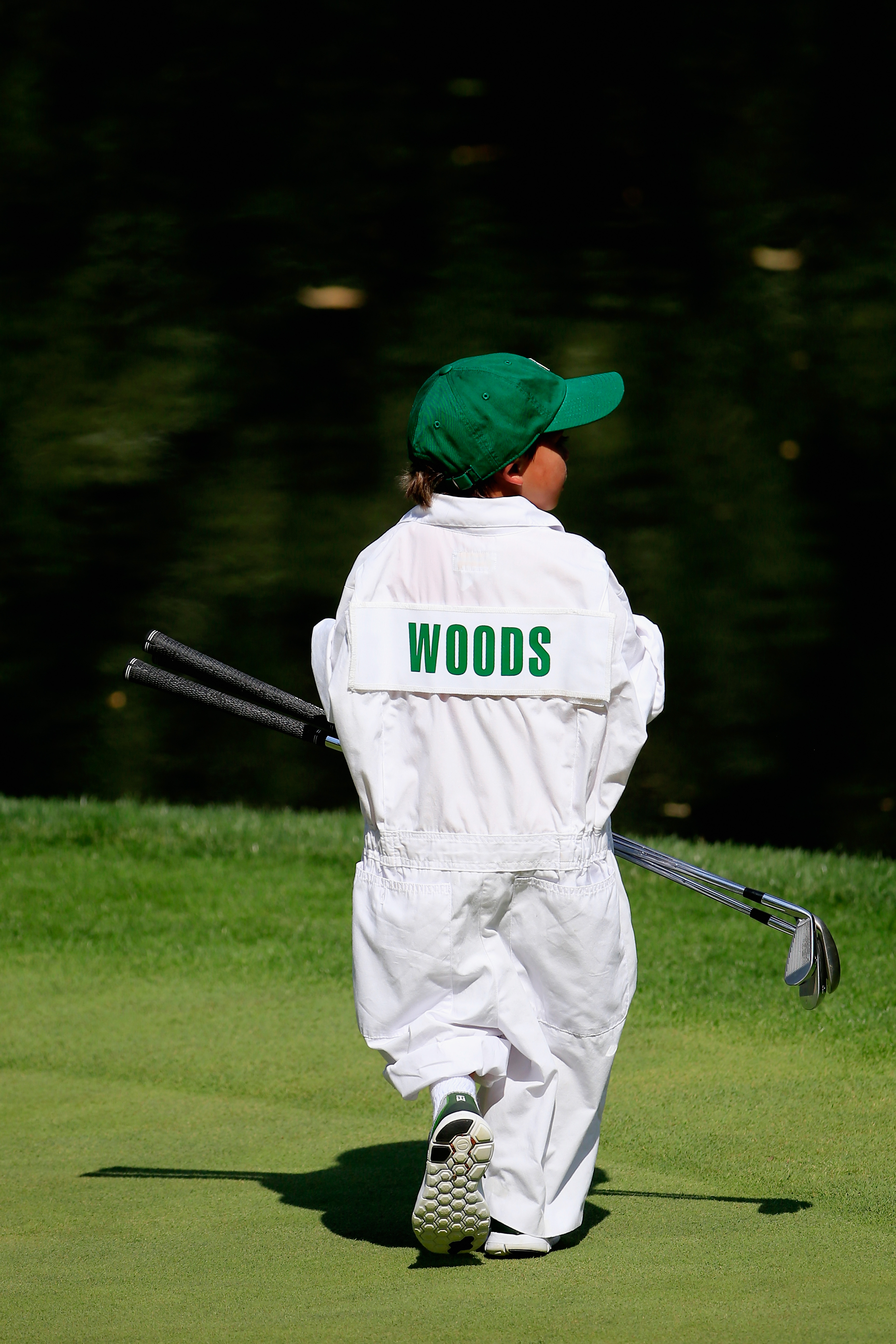 Charlie Woods walks across a green during the Par 3 Contest prior to the start of the Masters Tournament at Augusta National Golf Club on April 8, 2015, in Augusta, Georgia | Source: Getty Images