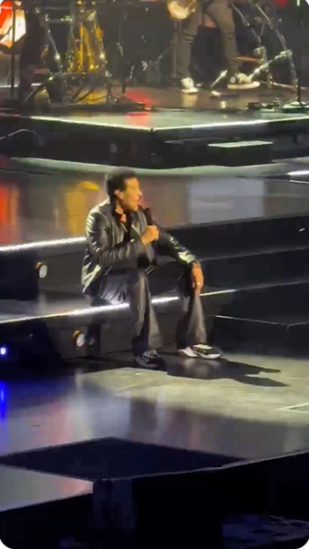 Lionel Richie sits on a set of illuminated stage steps while performing "Dancing on the Ceiling" at Grand Casino Arena in St. Paul, Minnesota, on June 25, 2026. | Source: X/Jon Bream