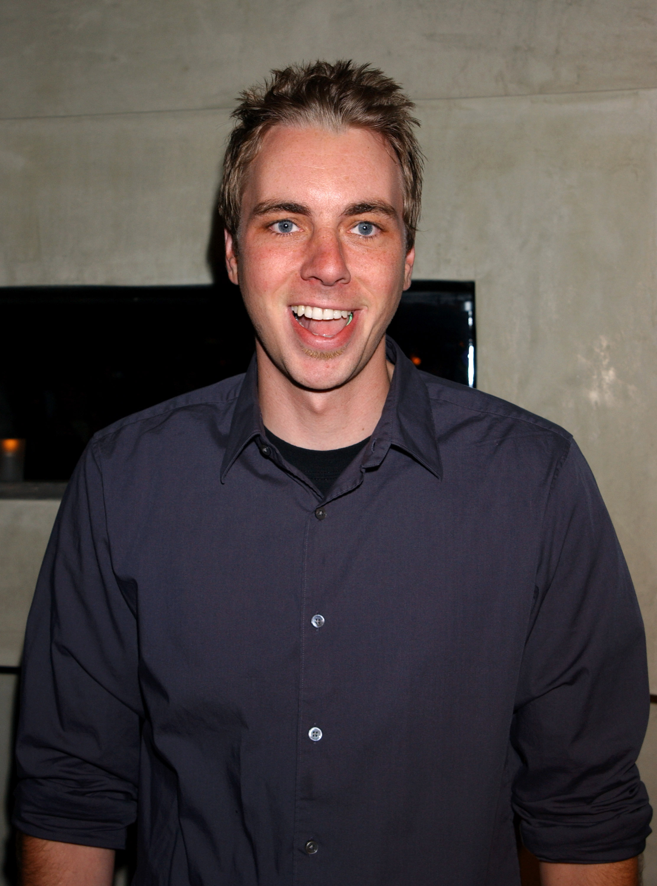 Fresh-faced and full of energy, Dax Shepard flashes a wide grin at a Hollywood party. His spiked hair and relaxed style reflect the early 2000s vibe he owned with ease.