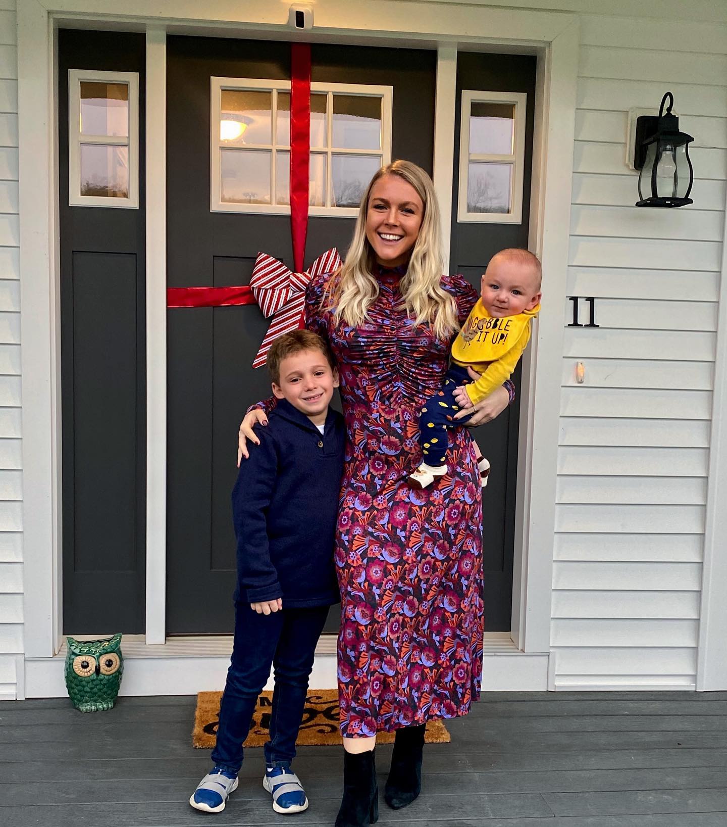 The Hampton property's covered porch is visible in this cheerful holiday photo, where the front doors have been transformed into an oversized Christmas present. It is a very different setting from Washington, and one that could become more significant now that Leavitt is stepping away from her daily White House duties. | Source: Instagram/karolineleavitt