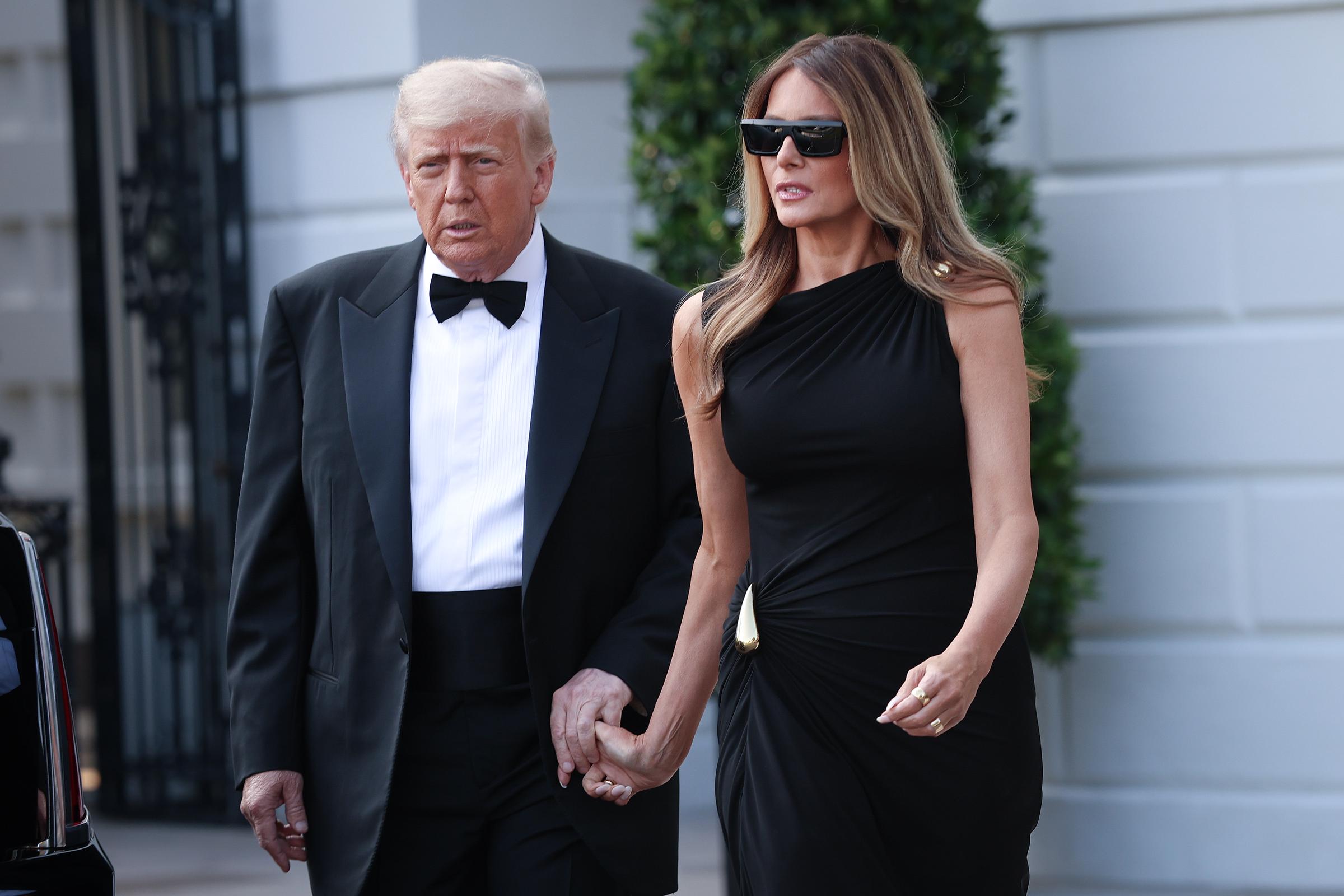 Against the backdrop of the West Wing, the president and first lady make a poised exit, their coordinated stride underscoring the formal tone of the evening.