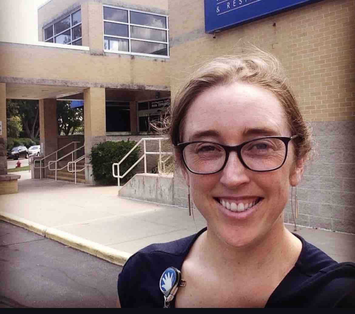 Dr. Julia Pederson smiles in an outdoor selfie taken outside a medical facility, wearing her pediatric badge and glasses. Having earned degrees from Harvard and Stanford before completing her residency at Lurie Children's Hospital of Chicago, she joined UPMC Children's Community Pediatrics in Pennsylvania in February 2026, where her compassionate care and ability to speak Spanish quickly endeared her to local families. | Source: GoFundMe