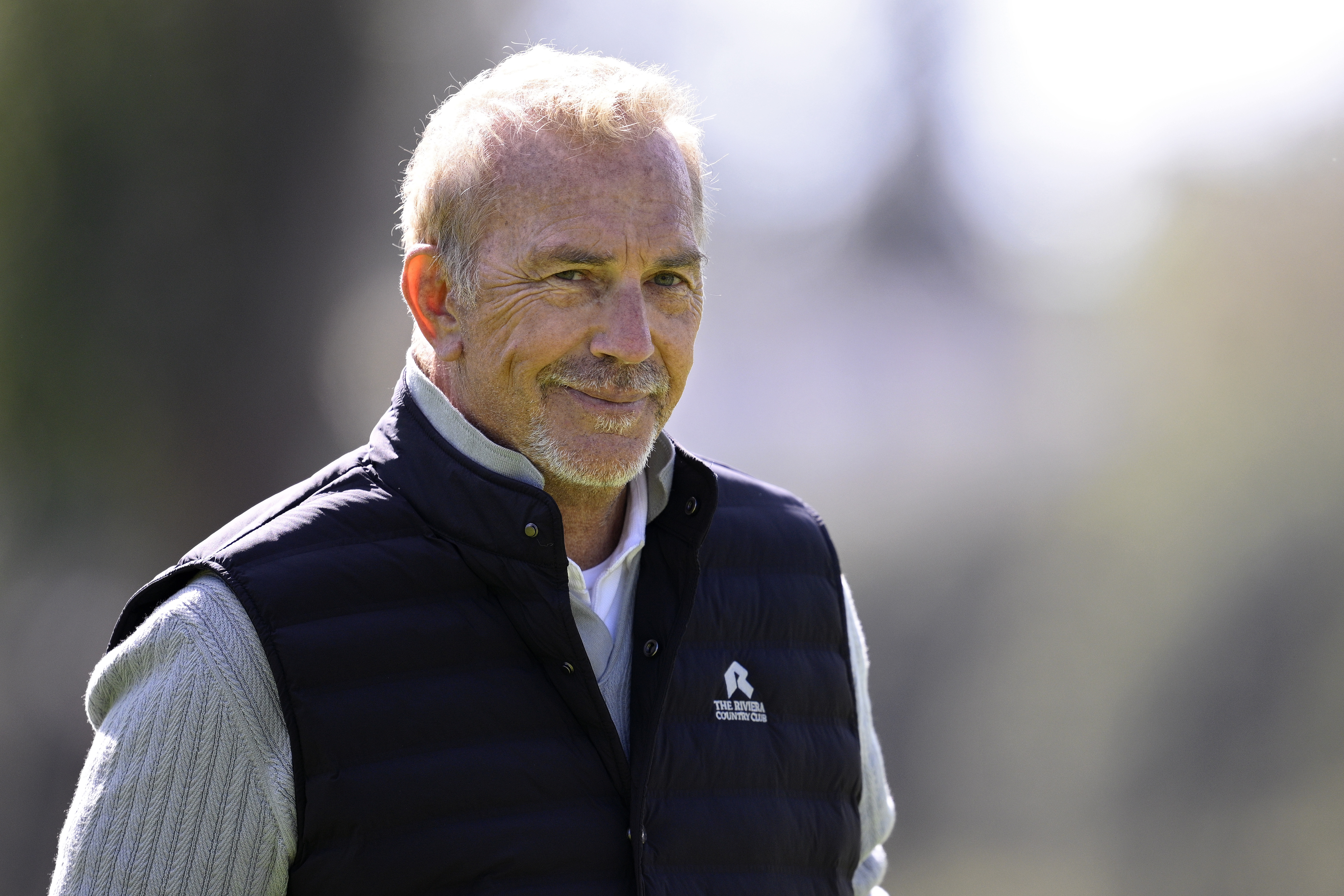 Kevin Costner looks on before The Genesis Invitational 2026 at Riviera Country Club in Pacific Palisades, California, on February 18. At 71, the acclaimed actor continued making public appearances while displaying the enduring screen presence that has defined his remarkable Hollywood legacy for decades.