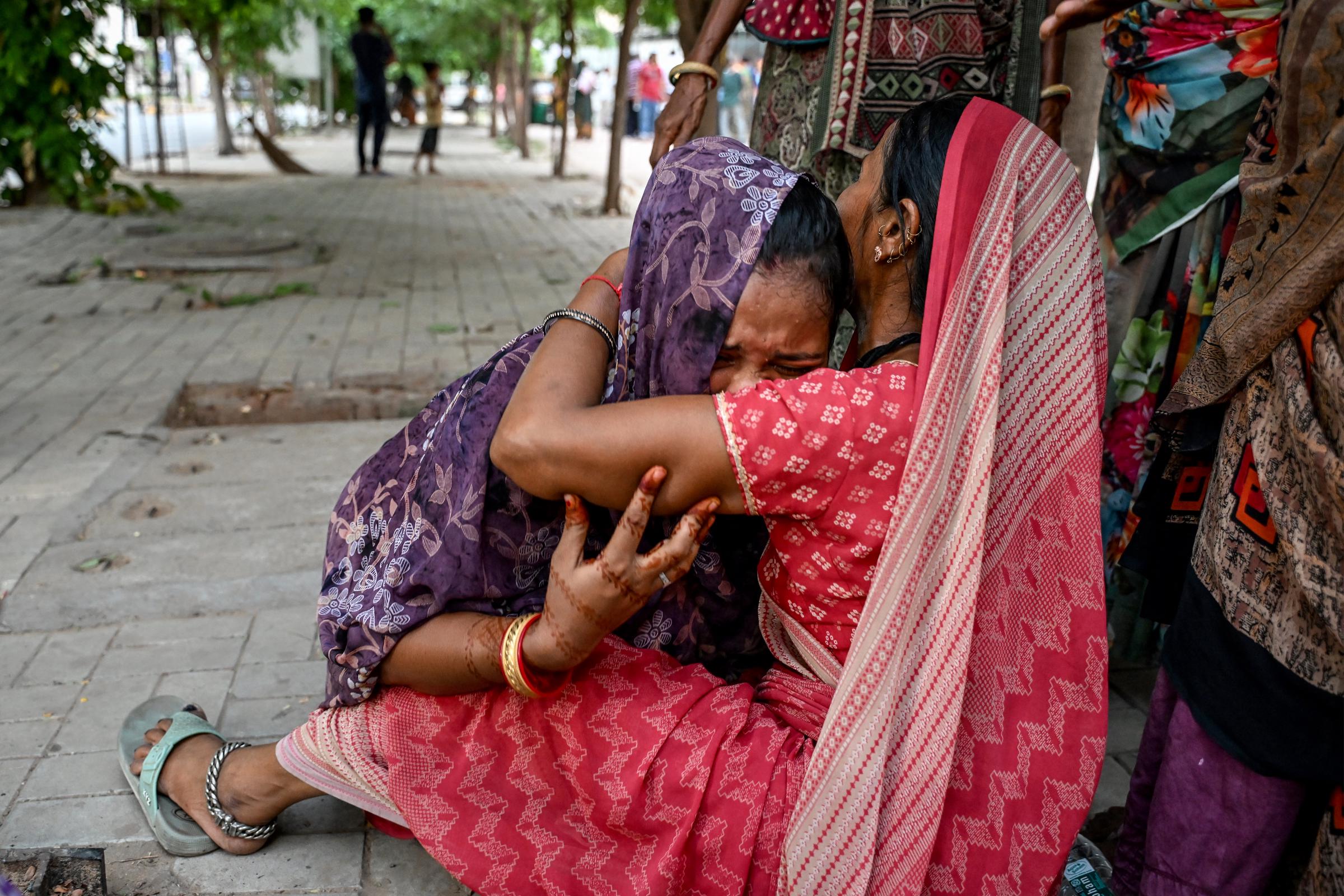 Women mourn their relatives killed by the Air India crash outside the hospital mortuary in Ahmedabad on June 13, 2025 | Source: Getty Images