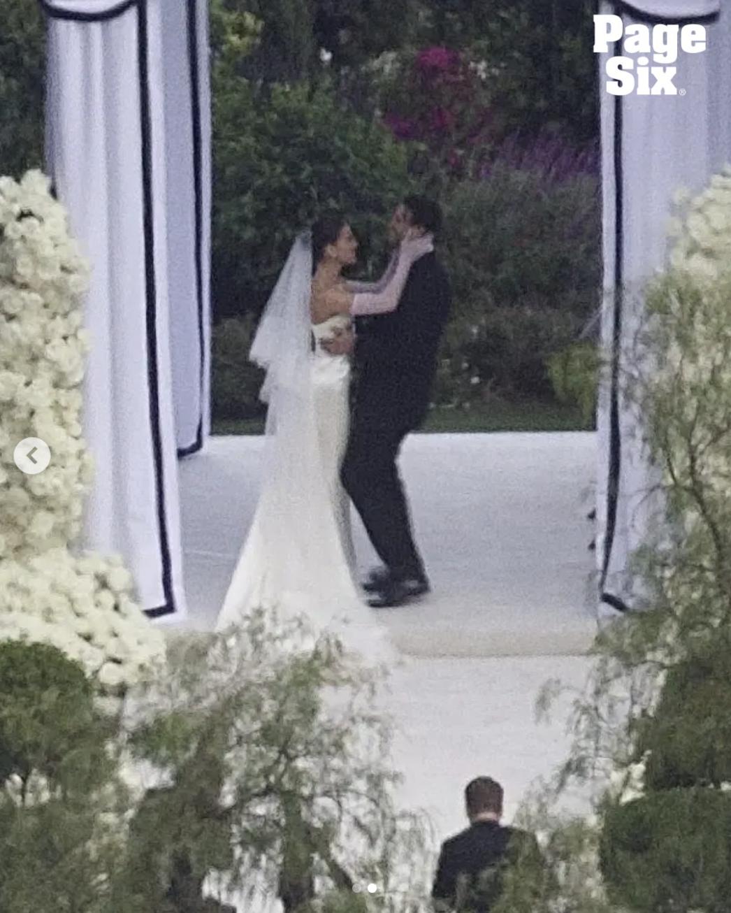 Hailee Steinfeld and Josh Allen stand together beneath the floral arch during their wedding ceremony | Source: Instagram/pagesix