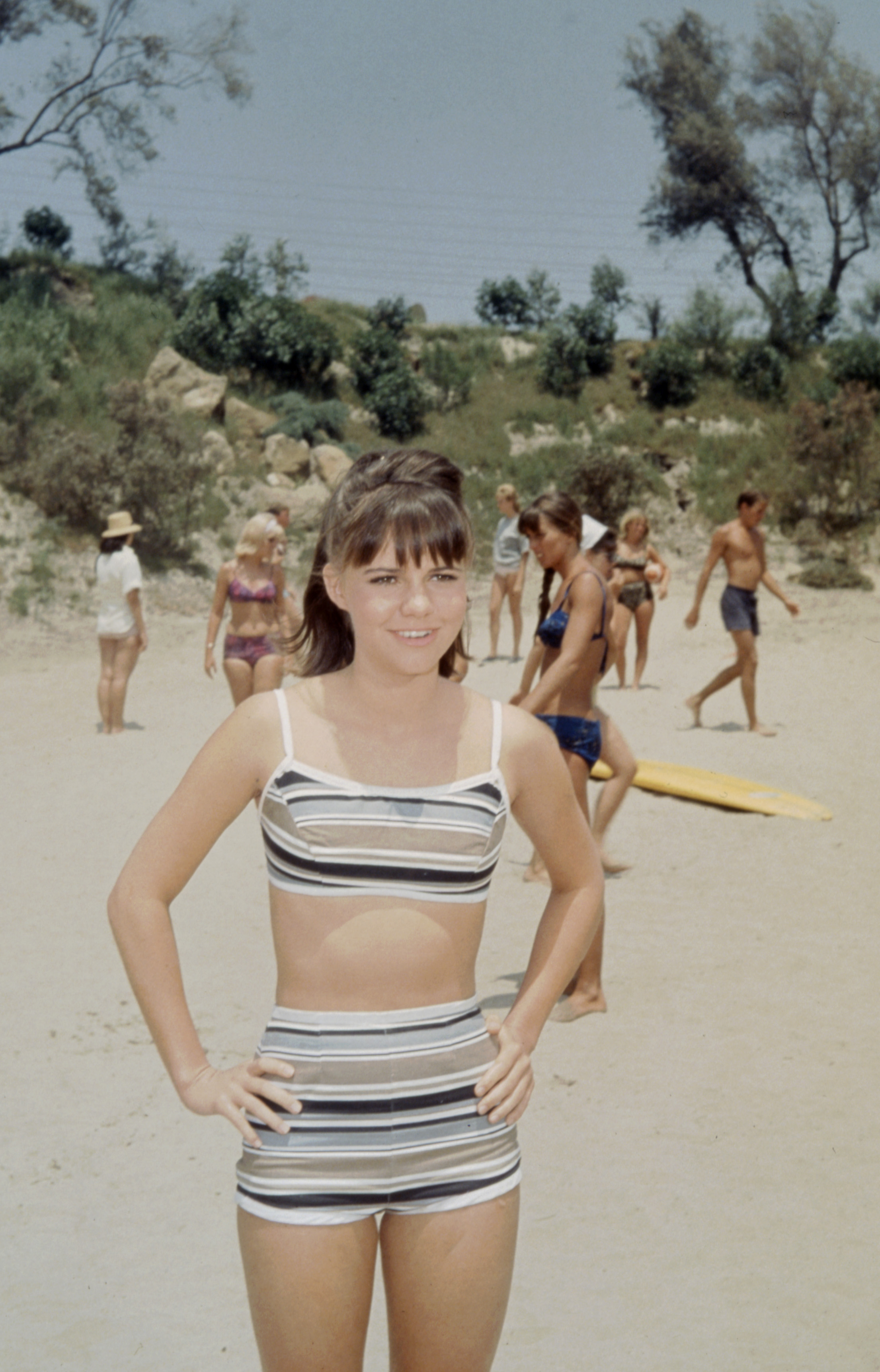 Sally Field at 19, starring in the ABC TV series "Gidget," radiates youthful confidence as she poses in a swimsuit, hands on her waist and a glorious smile lighting up her face.
