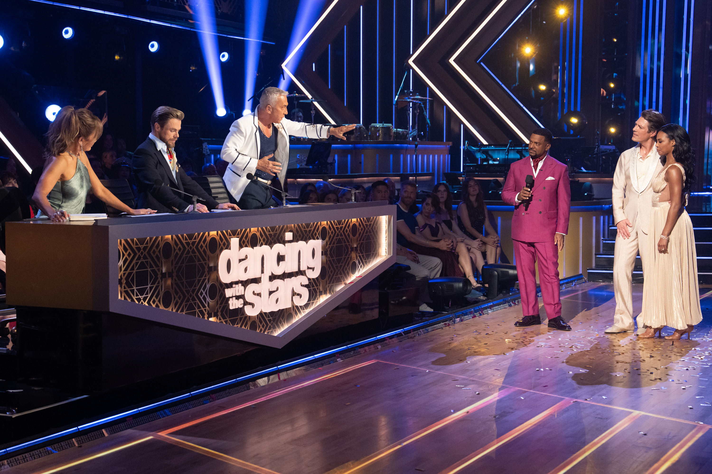 1. Taylor Hanson and Britt Stewart stand before judges Carrie Ann Inaba, Derek Hough, and Bruno Tonioli alongside host Alfonso Ribeiro during "Dancing with the Stars" Yacht Rock Night. | Source: Getty Images