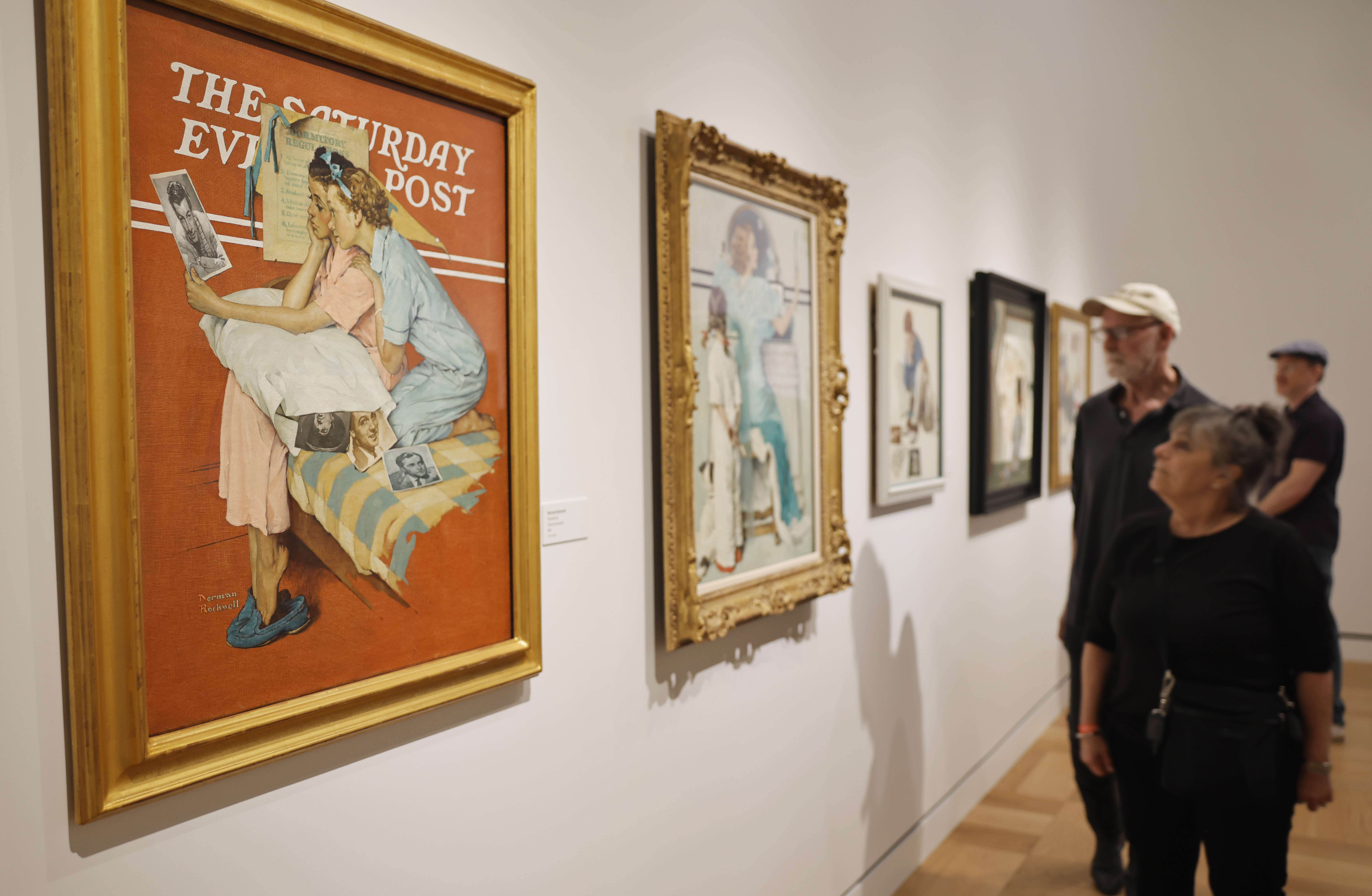 Art patrons admired classic Norman Rockwell illustrations in a gallery during the sold-out opening day of the Lucas Museum of Narrative Art on September 22, 2026, in Los Angeles, California. Founded by filmmaker George Lucas and Mellody Hobson within a massive 300,000-square-foot campus in Exposition Park, the institution debuted its visual storytelling collection with framed original works, including Rockwell's iconic depictions created for The Saturday Evening Post. | Source: Getty Images