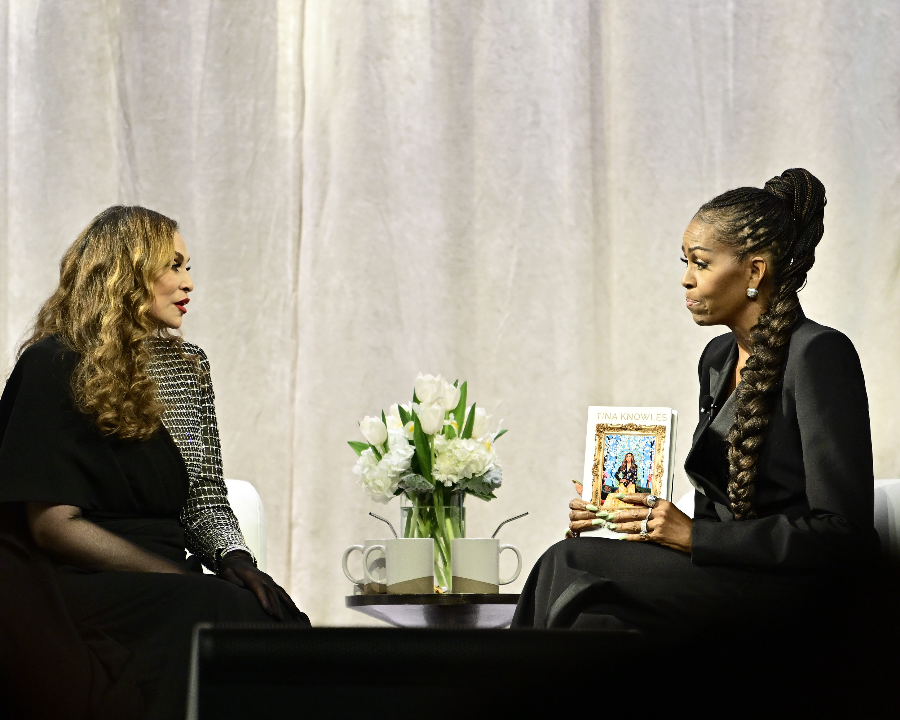 Tina Knowles discusses her memoir, "Matriarch", with former First Lady Michelle Obama at Matriarch - An Evening with Tina Knowles at The Theater at MGM National Harbor on April 30, 2025, in National Harbor, Maryland. | Source: Getty Images
