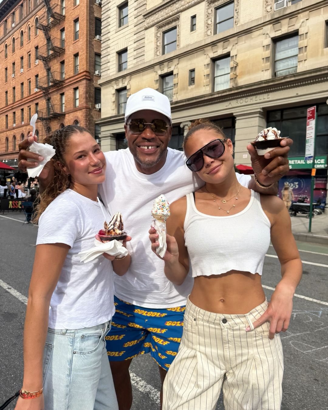 Michael Strahan enjoys ice cream with Isabella and Sophia during a family outing, one of the everyday moments featured in his birthday photo collection. | Source: Instagram/michaelstrahan