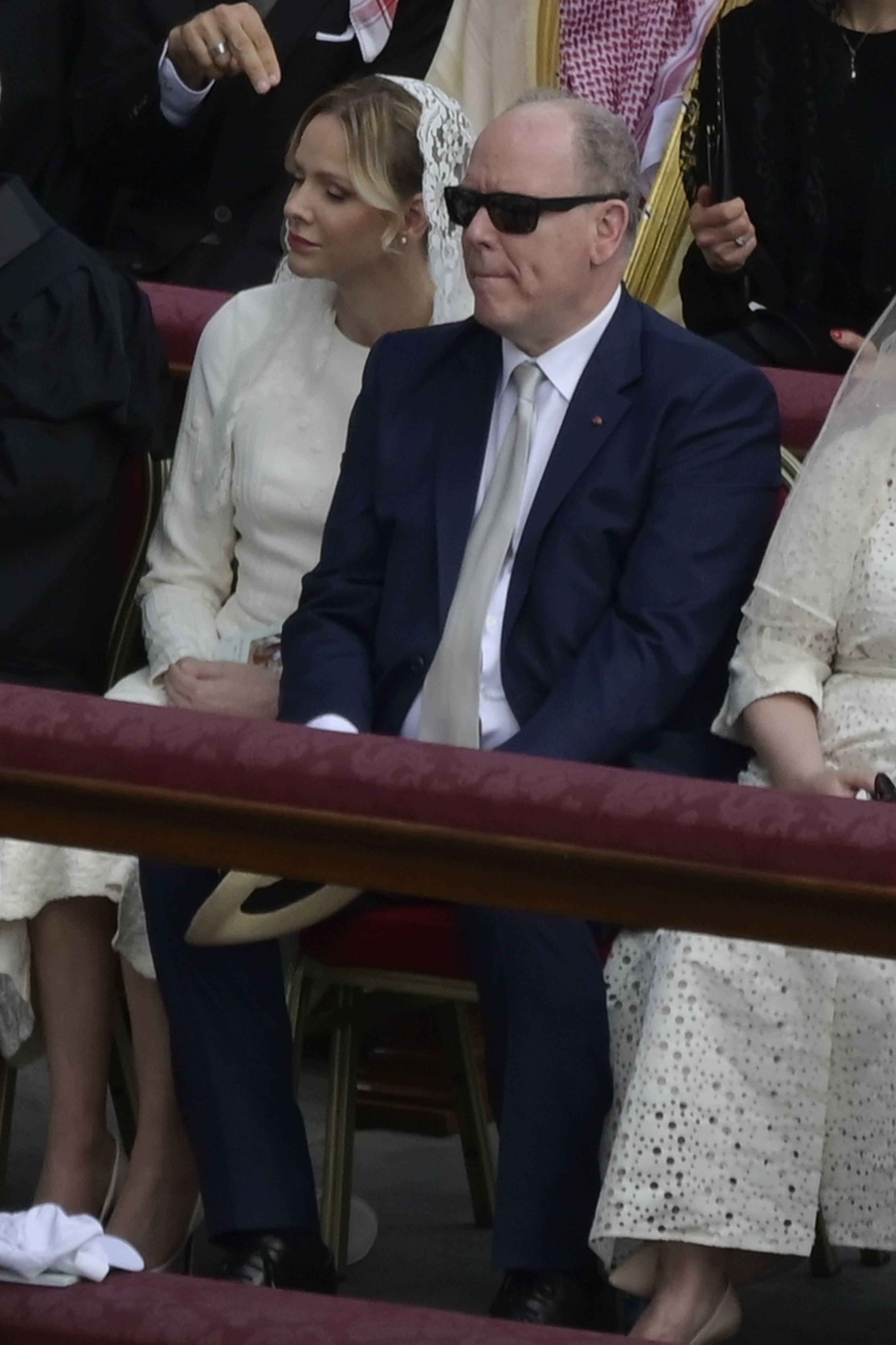 Prince Albert II of Monaco and Princess Charlene of Monaco are seen seated at the Vatican during the inauguration mass of Pope Leo XIV on May 18, 2025, with Princess Charlene dressed in white with a lace veil in line with tradition.
