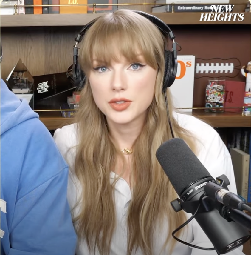 Taylor Swift looks glamorous in cat-eye liner and nude lipstick as she chats with Jason and Travis Kelce on the "New Heights" podcast. From a post dated August 14, 2025 | Source: Youtube/@newheightshow