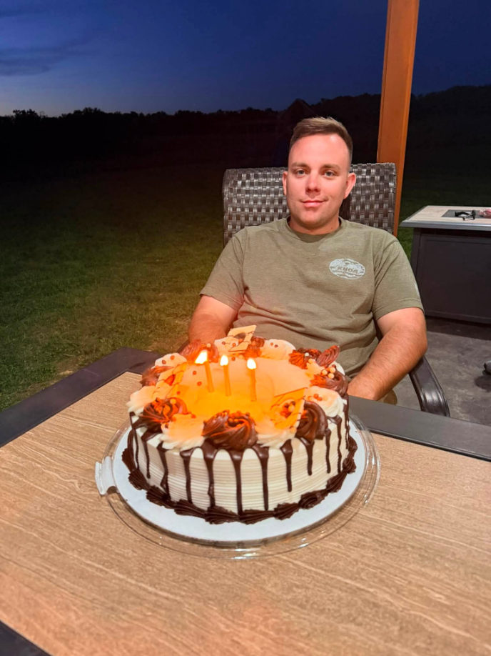 Hayden Phillips is pictured celebrating his birthday with a cake in a photo shared by his wife, Jordan, who recalled how she and their sons celebrated him early and treasured the time they had together. | Source: Facebook/Jordan Phillips