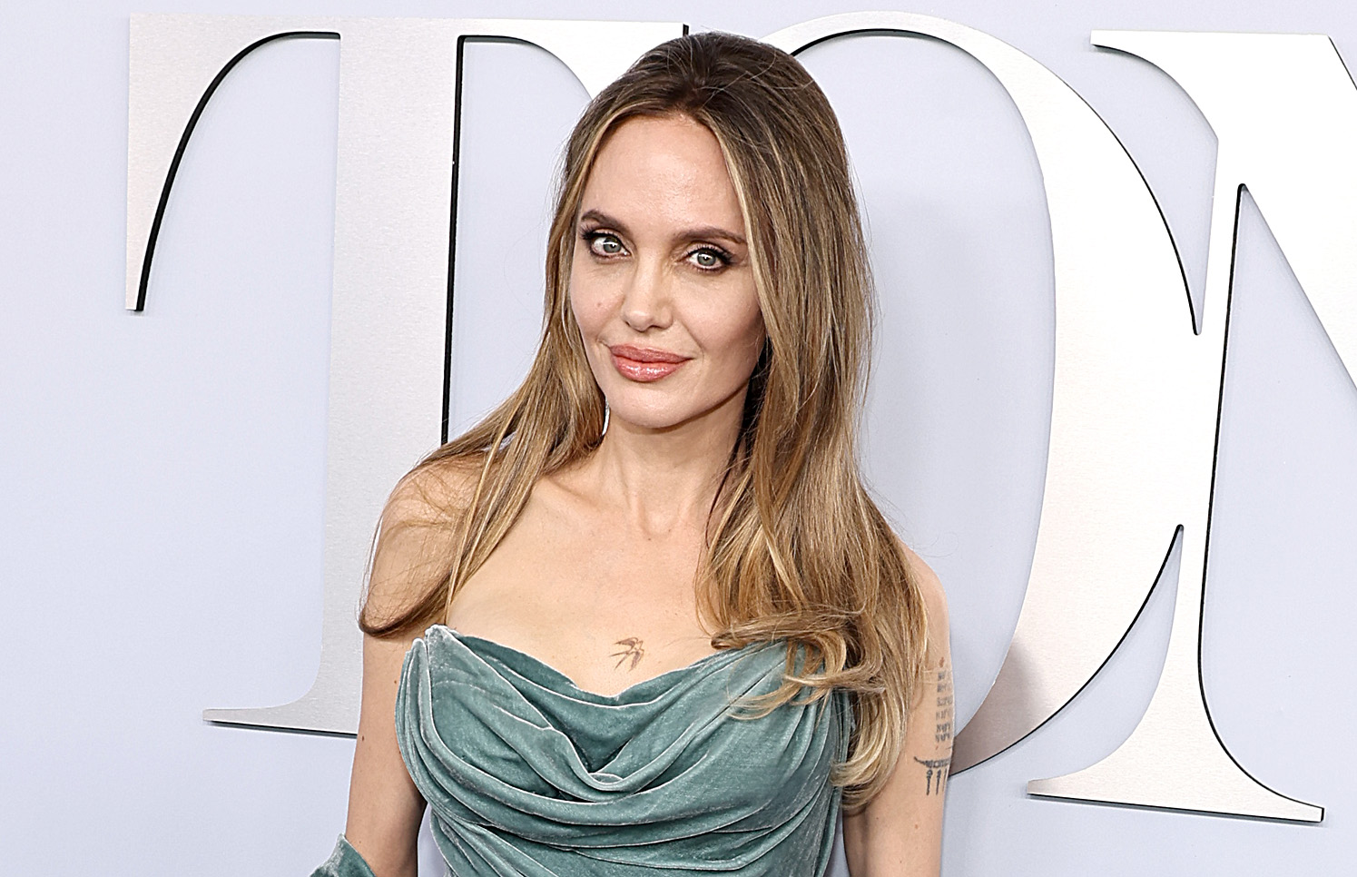 For the Tony Awards, Jolie chose a golden blonde blowout. Her hair was center-parted with soft bends at the ends and subtle volume toward the lower half.