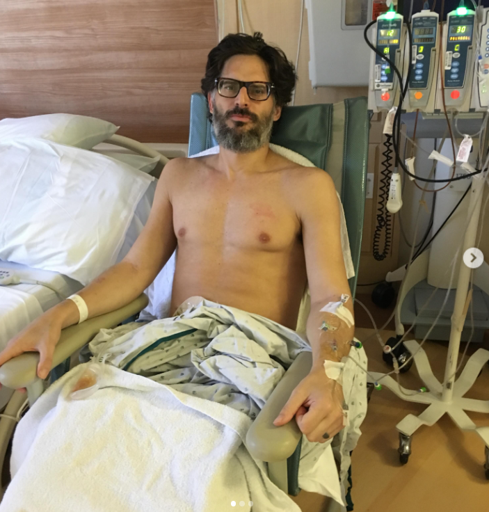 Joe Manganiello sits in a hospital chair with medical tubes attached to his arms in a photo shared on social media in October 2026. The actor revealed that he lost 60 pounds in the two weeks following emergency surgery to remove his large intestine in 2016. | Source: Instagram/joemanganiello
