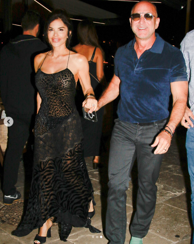 Jeff Bezos  and Lauren Sanchez hold hands and smile as Bezos leads Sanchez through a Saint-Tropez restaurant, from a post dated July 23, 2025. | Source: Instagram/PageSix