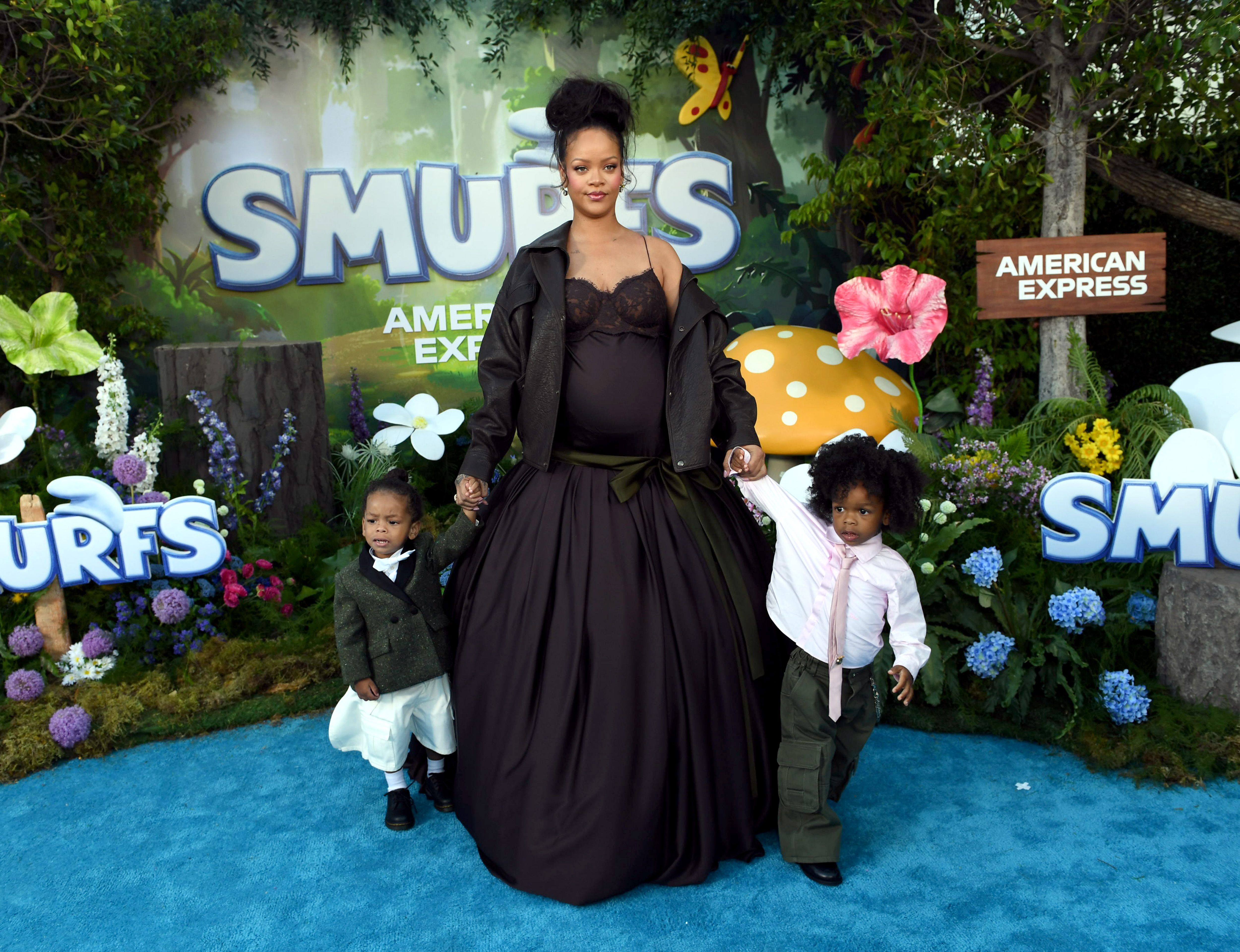 Rihanna holding hands with her sons Riot Rose Mayers and RZA Athelston Mayers at the Los Angeles premiere of ''Smurfs." | Source: Getty Images