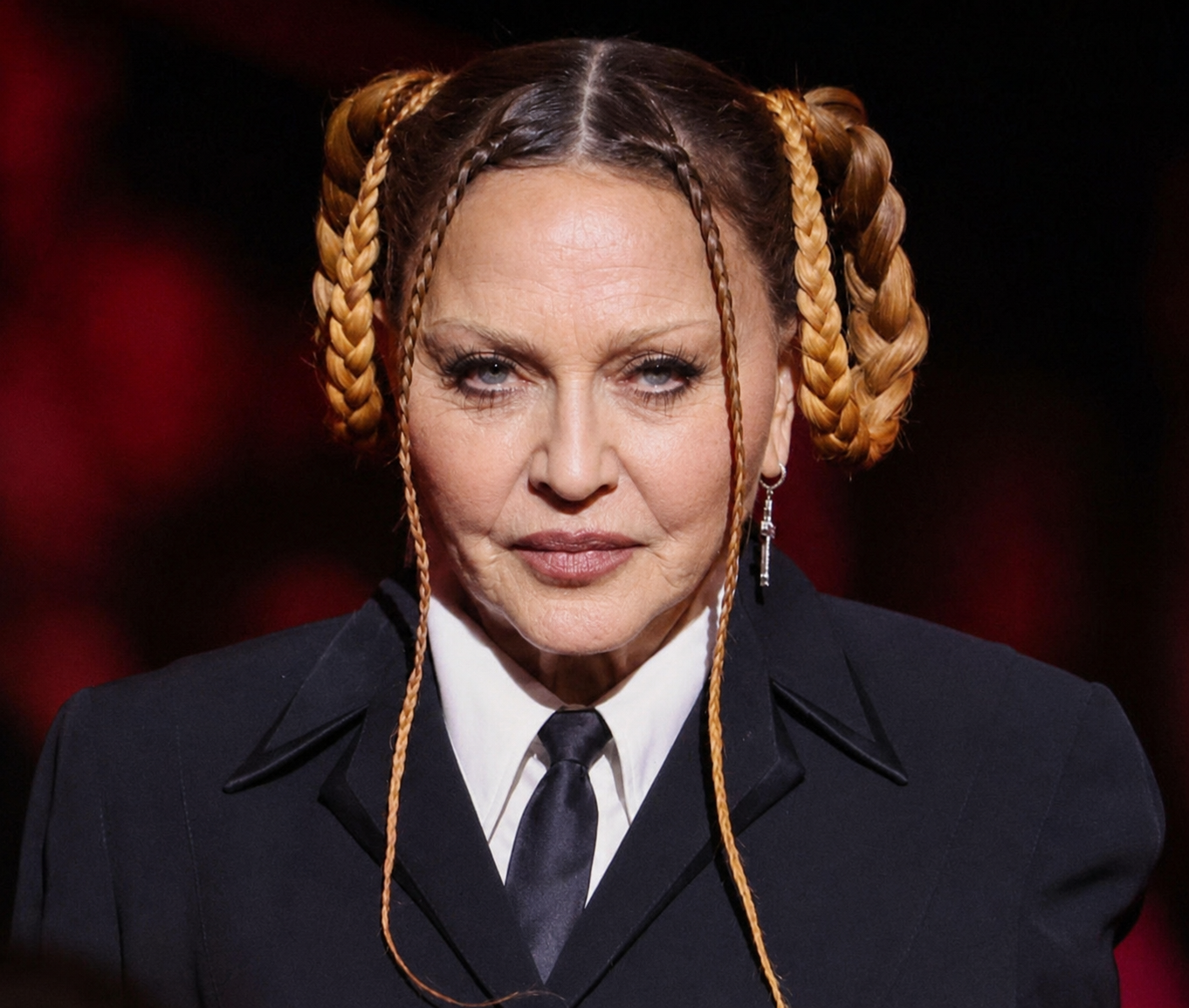 In the AI interpretation, Madonna's distinctive braided hairstyle, tailored outfit and pose remain intact as her facial appearance is reimagined. | Source: Chat GPT