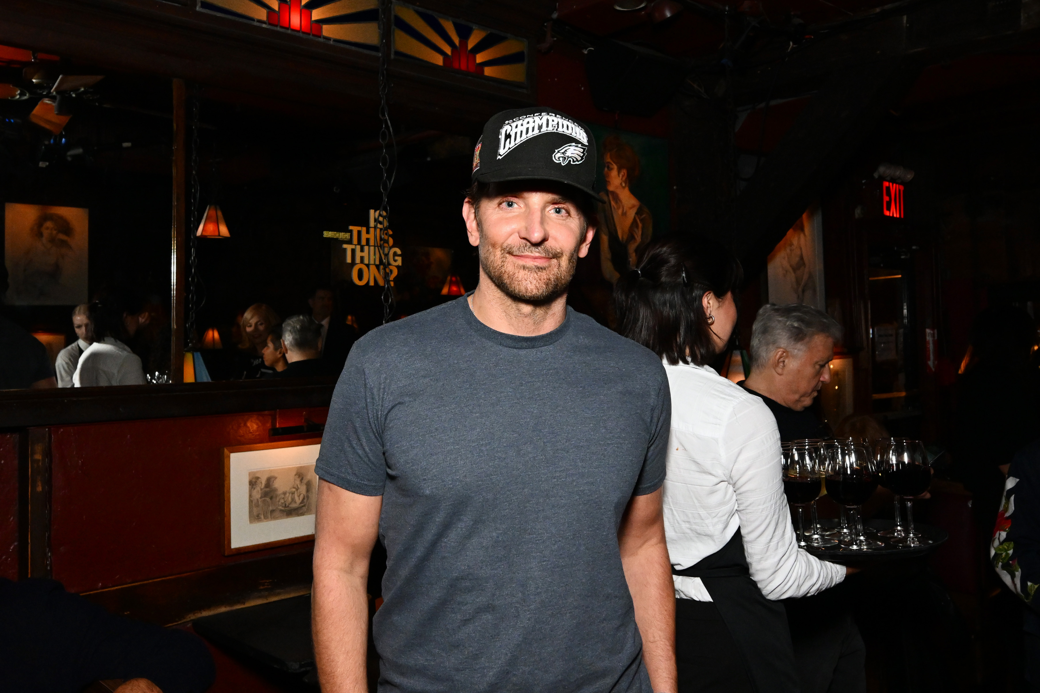 Cooper looked much more like himself here. He was seen with a confident, closed-mouth smile with pronounced crow's feet around his eyes, and wearing a short, distinguished beard of mixed brown and gray hairs, all partially shadowed by a baseball cap, as he attended the "Is This Thing On" world premiere afterparty during the 63rd annual New York Film Festival at the Comedy Cellar on October 10, 2025, in New York City.