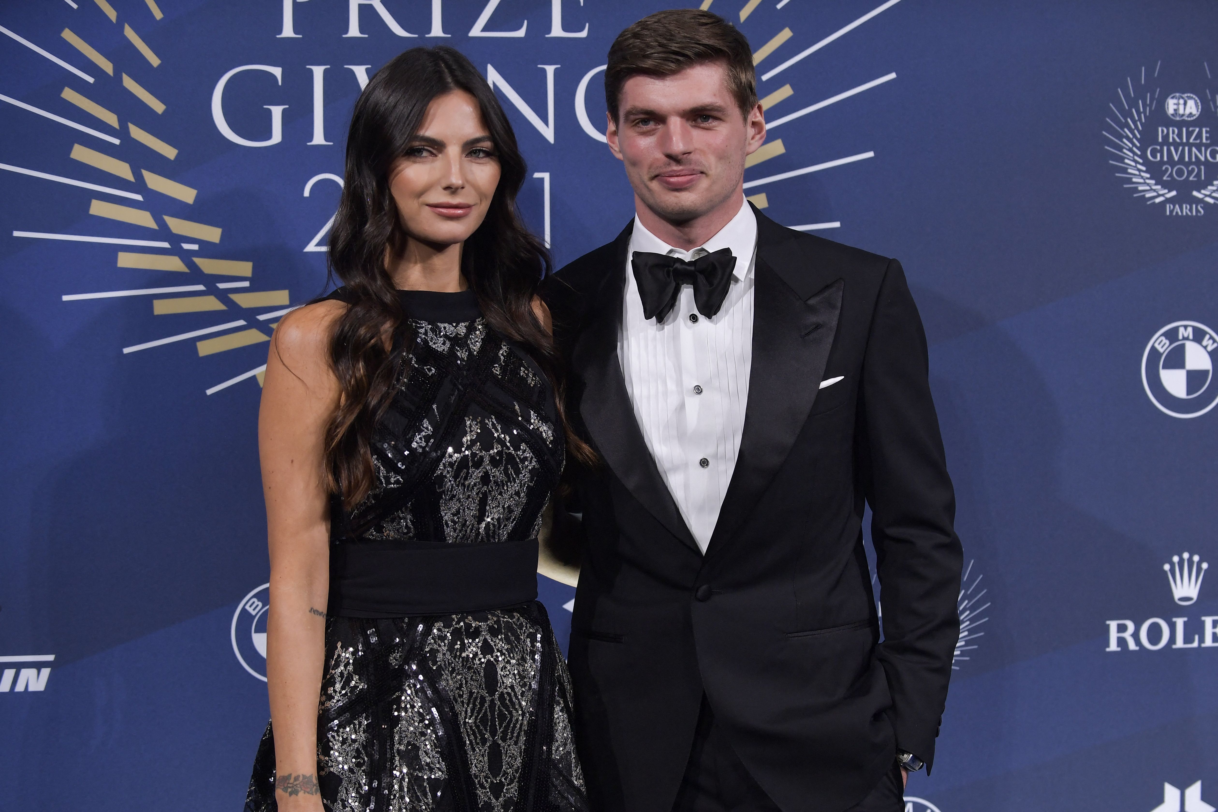 Max Verstappen and Kelly Piquet pose on the blue carpet ahead of the FIA Prize Giving gala in Paris, on December 16, 2021, showcasing their glamorous side away from the racetrack.