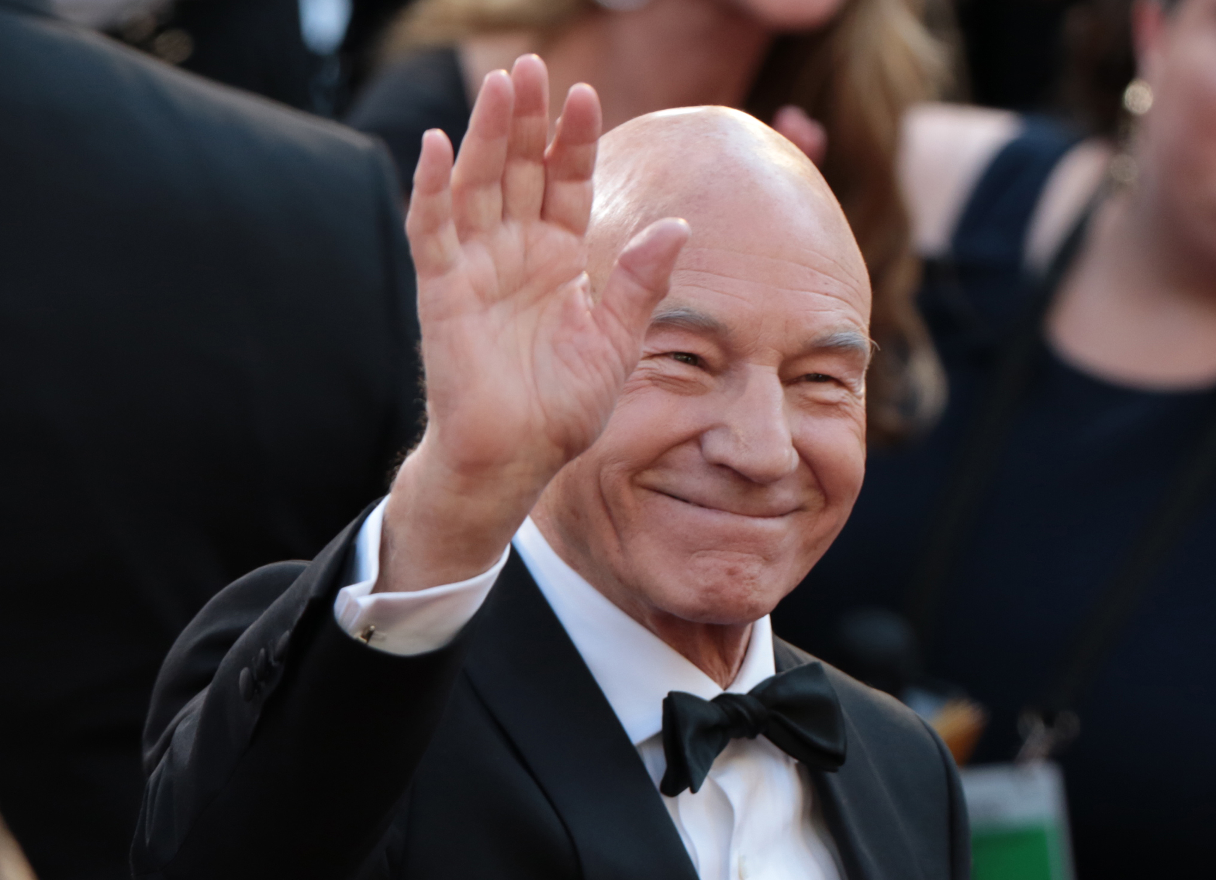 Patrick Stewart smiles and waves at the 2018 Academy Awards. Years later, a Facebook announcement about the beloved actor would leave fans sharing heartfelt messages, including on his wife's Instagram page. | Source: Getty Images           Convert to PDF