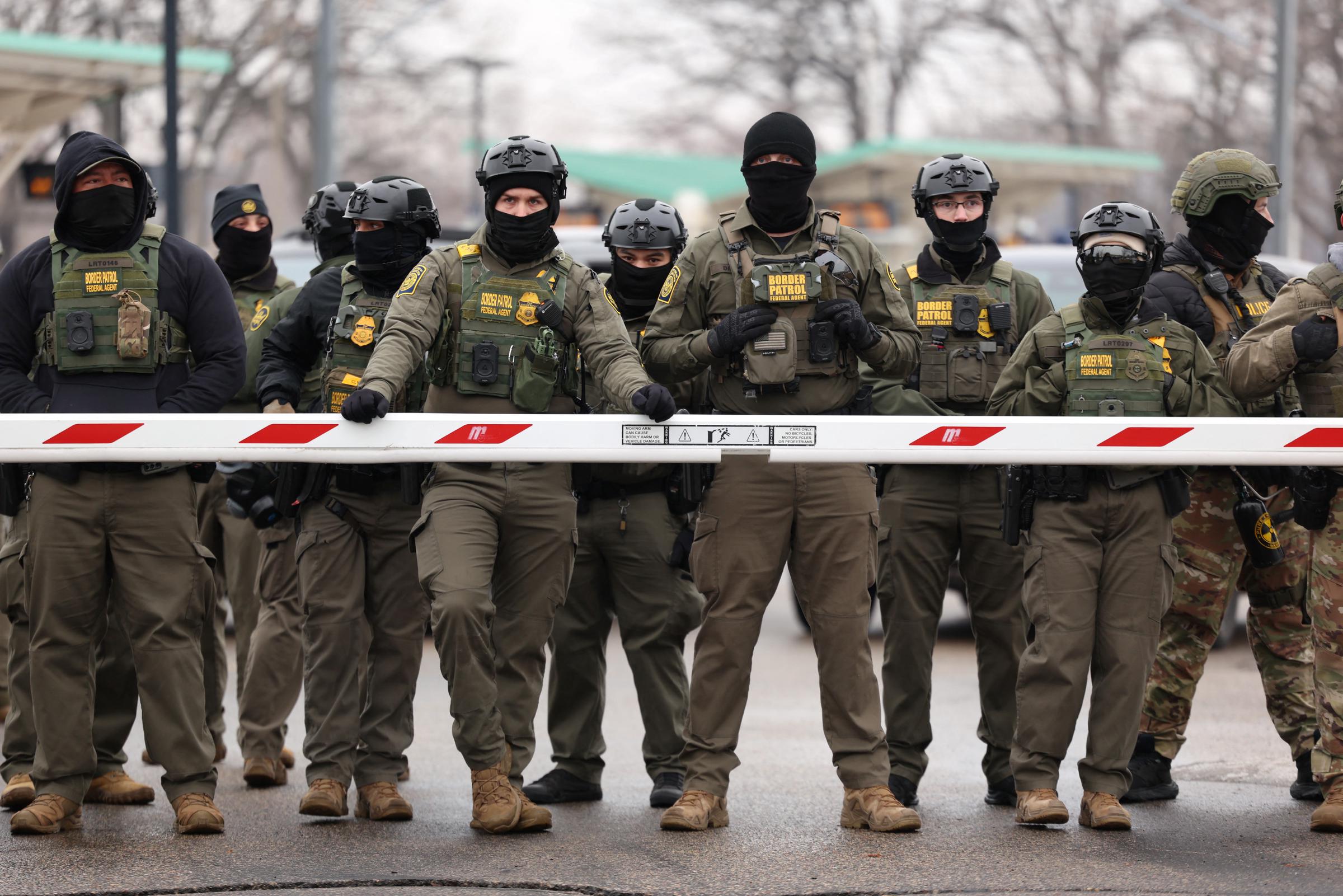 Federal agents stand guard during an immigration enforcement operation in Minneapolis, Minnesota. Source: Getty Images
