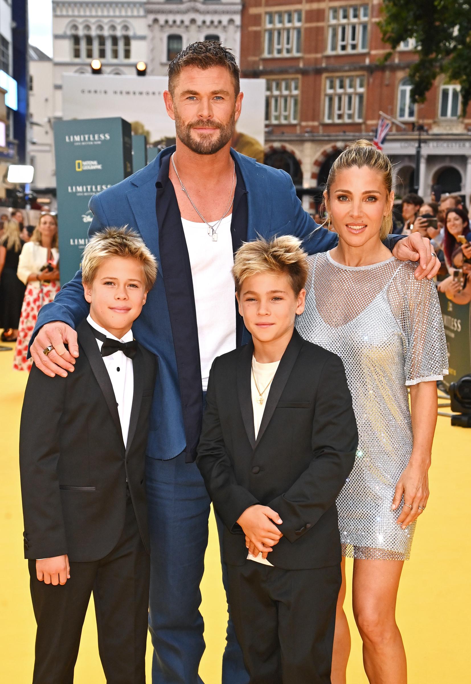 Chris Hemsworth and Elsa Pataky stand proudly with their 10-year-old twin sons, Tristan and Sasha, at the premiere of "Limitless: Live Better Now" on July 17, 2025. The boys wore sleek black suits — one with a bow tie and the other with layered gold chains — while their parents matched in stylish formalwear, exuding confidence as they posed for cameras.