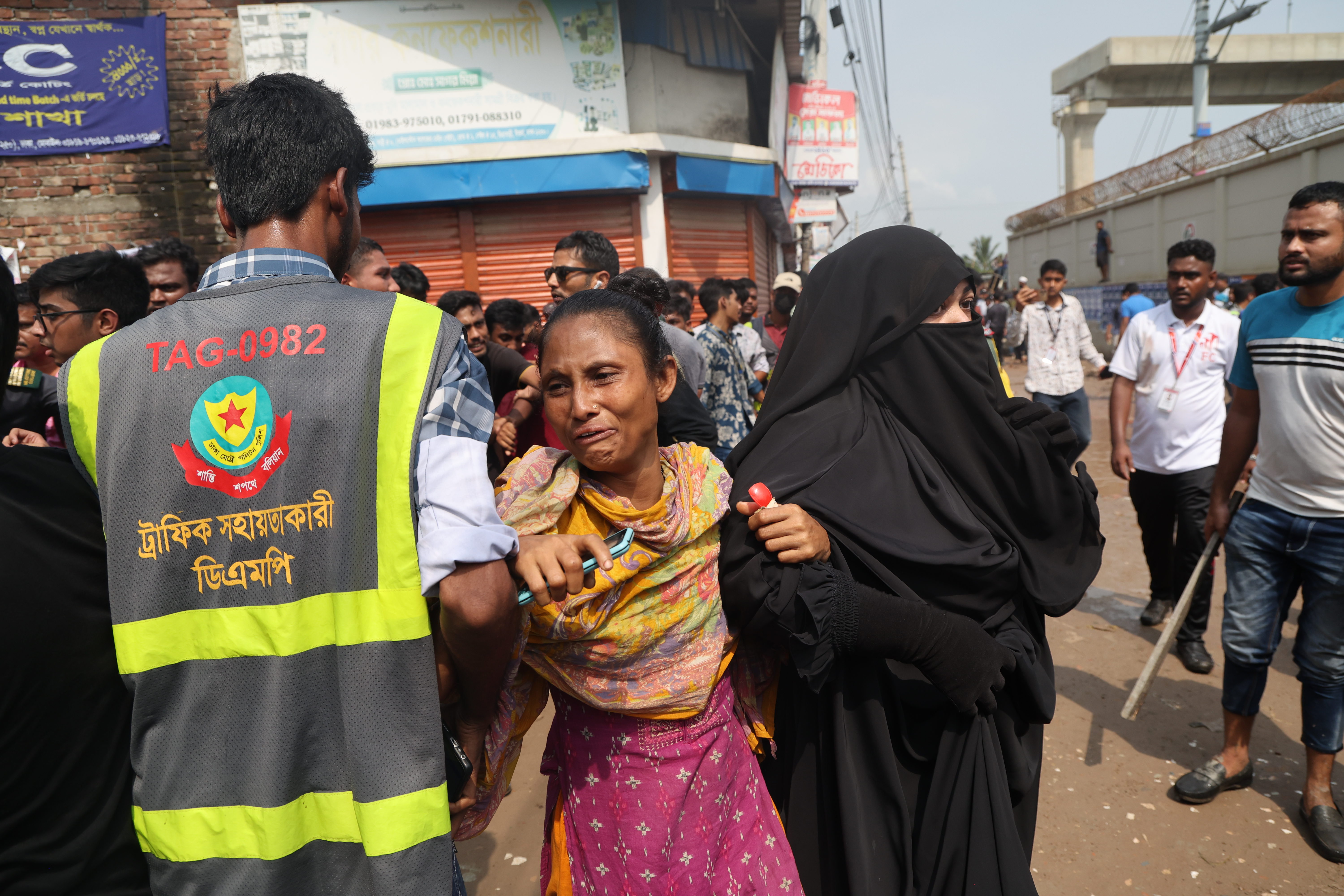 People react as they search for their loved ones after the Bangladesh Air Force F7 aircraft crashed into a building of Milestone College in Dhaka's Uttara in Dhaka, Bangladesh on July 21, 2025 | Source: Getty Images