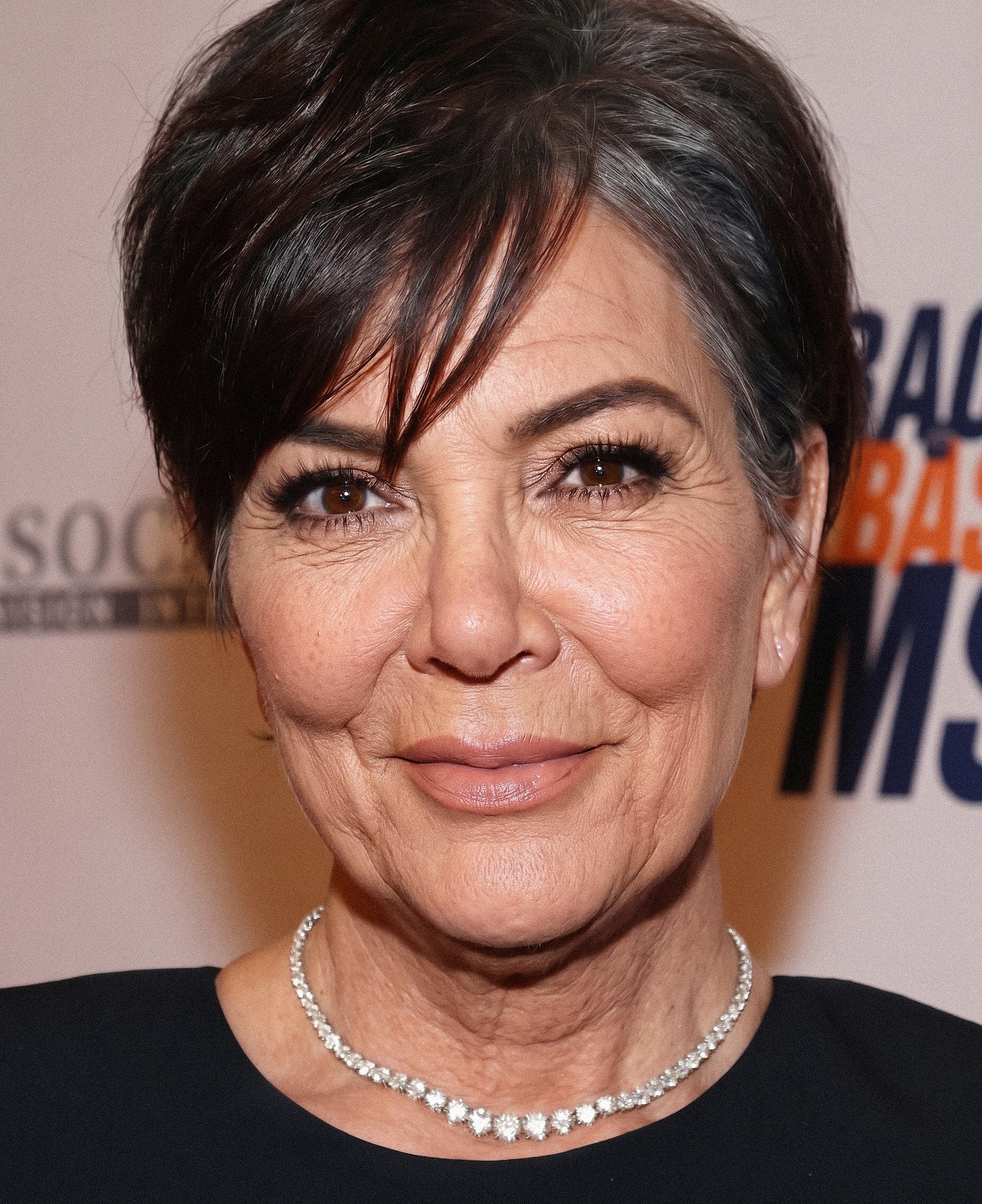 A more understated take on Kris shows gray at her temples and fine lines across her face, offering a striking contrast to her famously polished image. | Source: Gemini