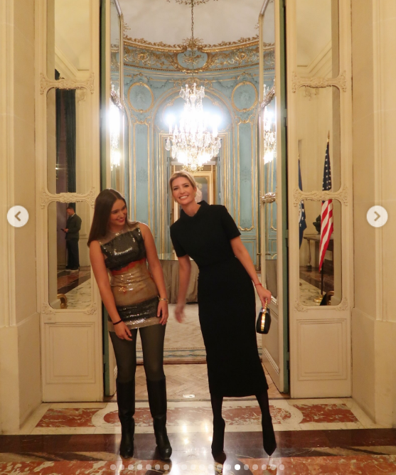 Sharing a laugh in an opulent gilded hall beneath a crystal chandelier, mother and daughter showed off playful energy against grand architectural mirrors and marble floors. Arabella rocked a modern ensemble of a sequined, color-blocked tube top layered over a mini skirt, black leggings, and knee-high boots, while Ivanka laughed along in a collared black short-sleeved midi dress. | Source: Instagram/ivankatrump