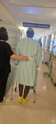 Carrie Everett being assisted in hospital by a medical professional. | Source: GoFundMe/Help Carrie beat cancer!