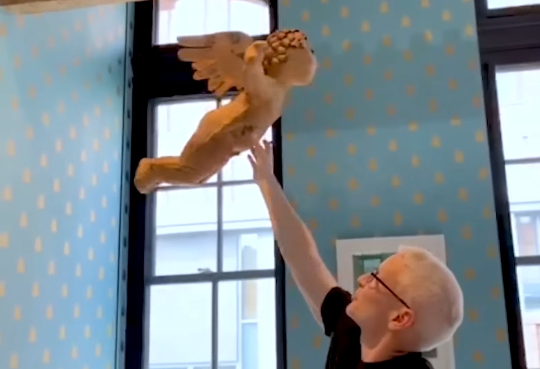 Anderson Cooper showing off a paper mache cupid in his son's nursery | Source: YouTube/PeopleTV