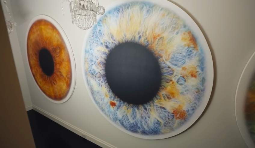 The oversized iris artworks bring a surreal, modern note to the suite area. They keep the home from feeling locked into one period style. | Source: YouTube/Architectural Digest