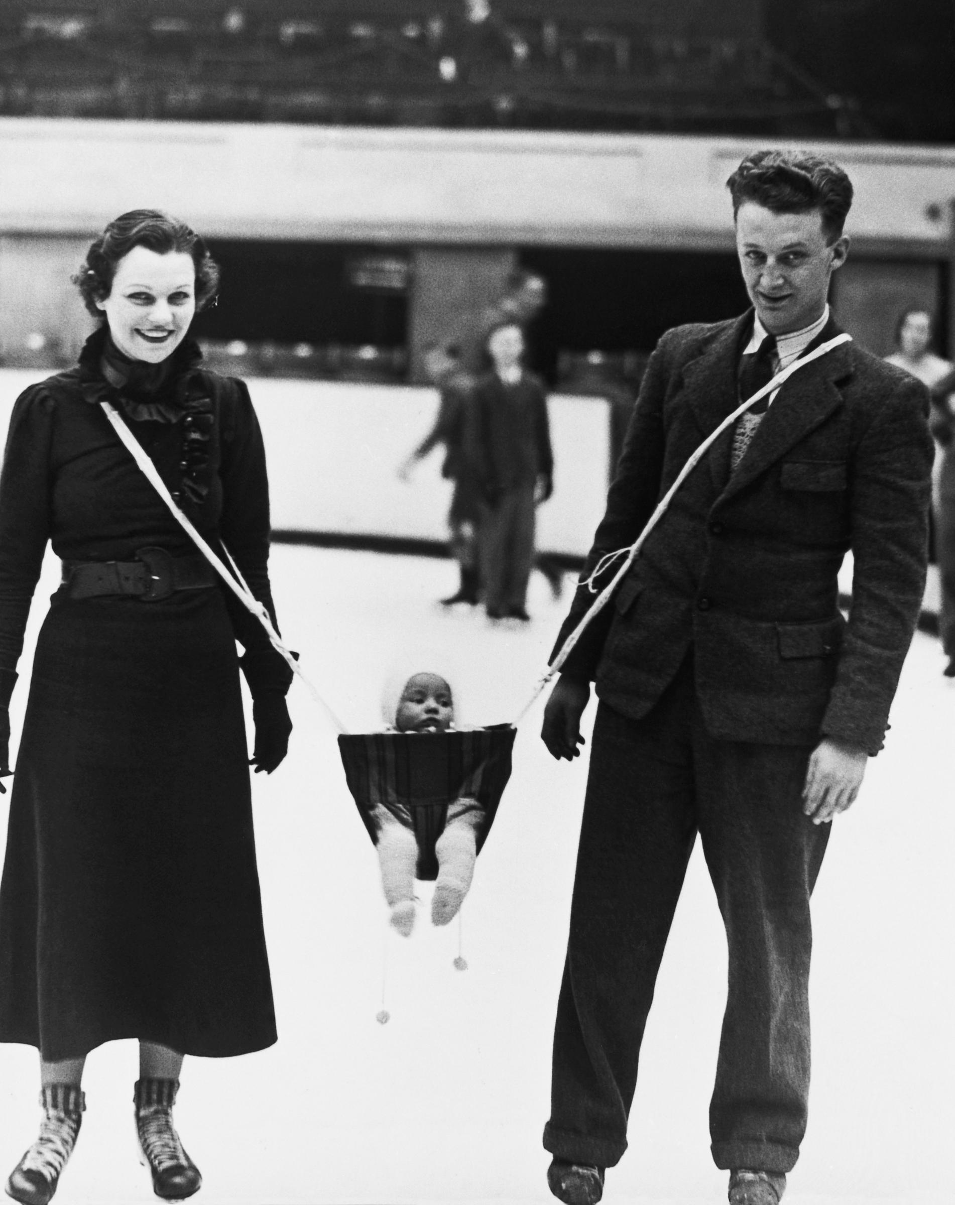 Hockey player skating with his wife and baby, 1937 | Source: Getty Images