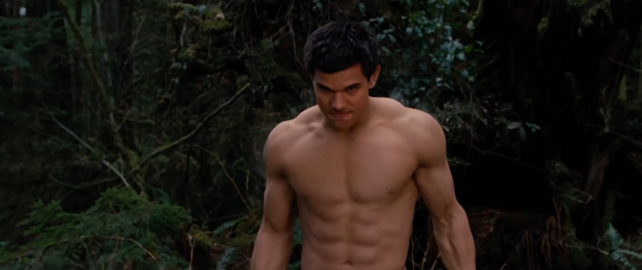 Taylor Lautner showed the muscular physique he developed to portray Jacob Black during a shirtless scene in the woods. | Source: YouTube/Movieclips