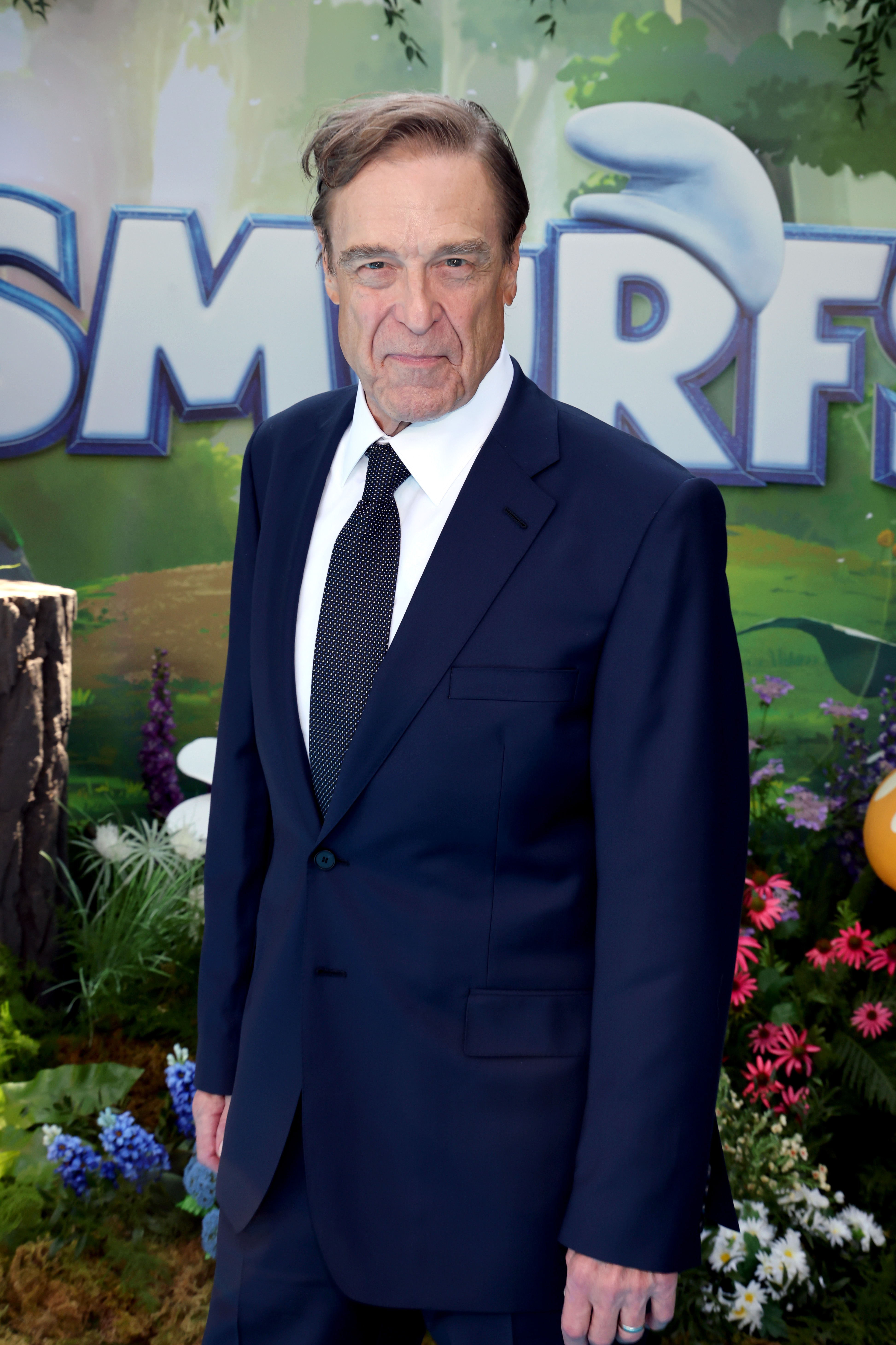 From a different angle at "The Smurfs Movie" premiere in 2025, Goodman showcased his newly achieved slimmer figure. The actor exuded confidence and style in a navy suit paired with a crisp white shirt and a dotted black tie.