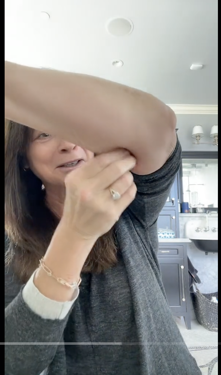 Valerie Bertinelli pokes her arm to show her sagging skin in a video shared on November 23, 2023 | Source: TikTok/@realwolfiesmom