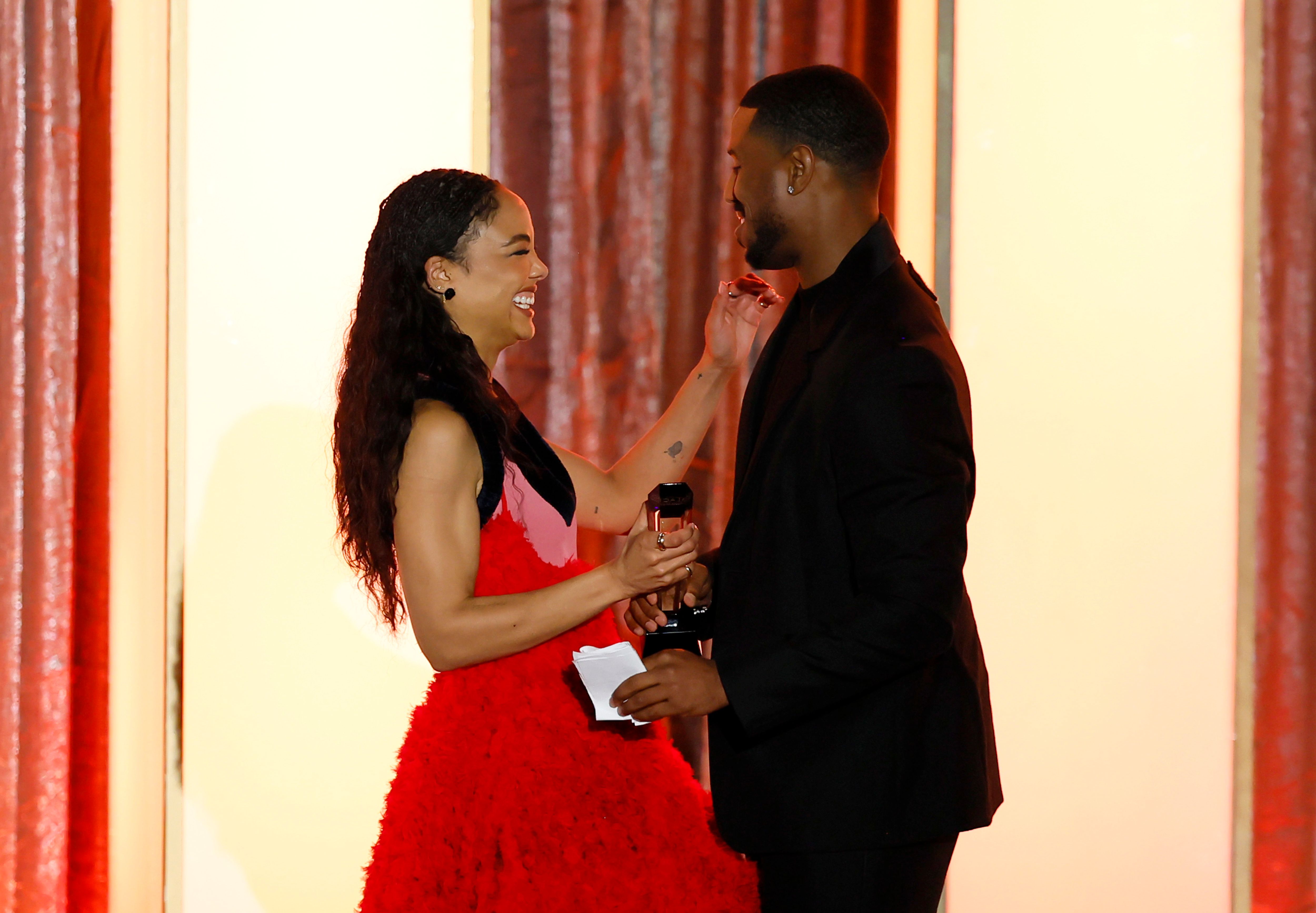 Michael B. Jordan presenting Tessa Thompson with the award she won for "Hedda" during the celebration event. | Source: Getty Images